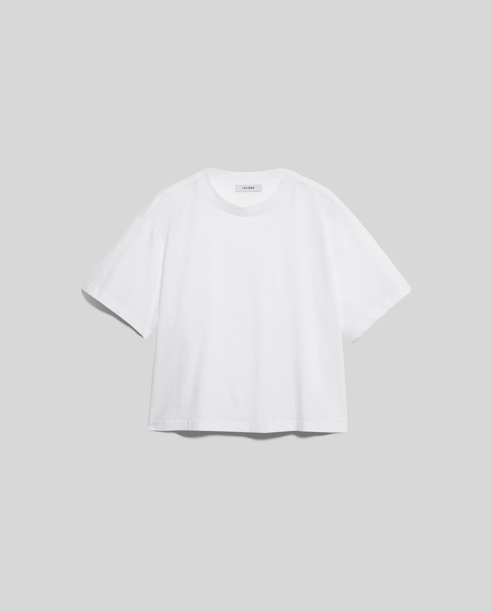 The KYLA Top by IVY OAK is a must-have plain white short-sleeve tee crafted from organic cotton, shown against a light gray background.