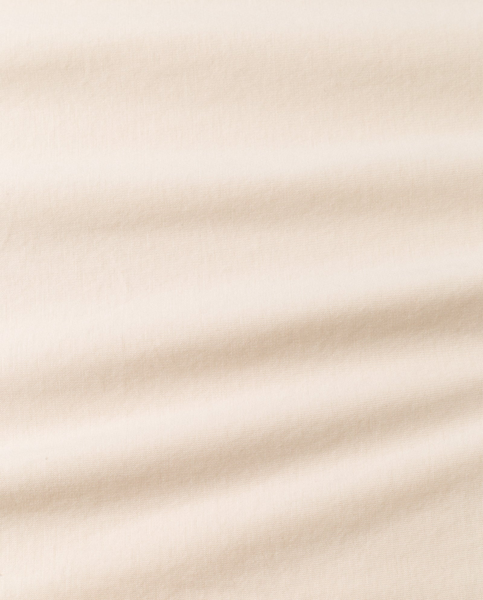 The KYLA Top by IVY OAK is crafted from beige organic cotton fabric, featuring subtle horizontal folds and a soft, smooth texture.