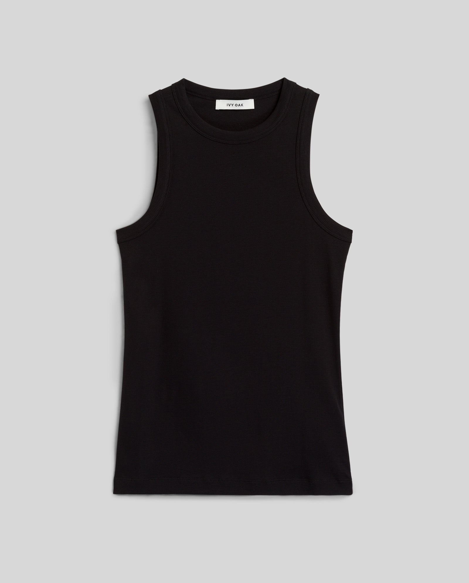 The IVY OAK KLARA ANN Top, a sleeveless black tank made from soft organic cotton, is laid flat on a light gray background.