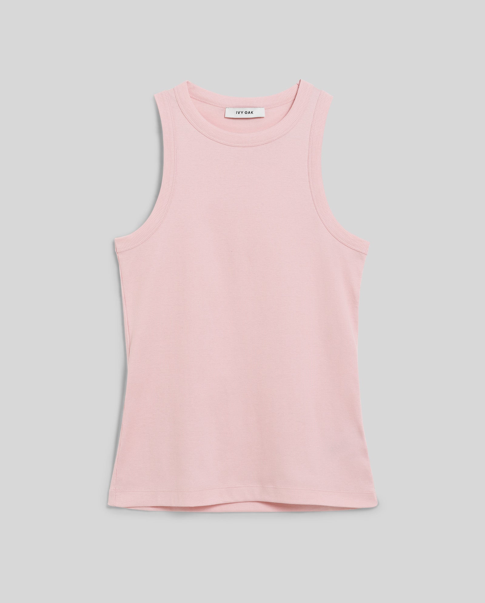 The IVY OAK KLARA ANN Top is a sleeveless light pink tank crafted from comfortable organic cotton with a rounded neckline, shown on a plain gray background.