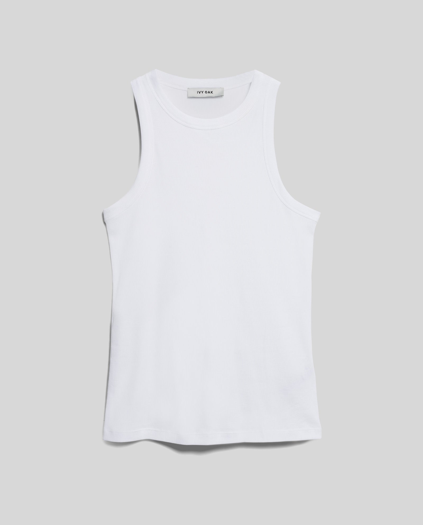 The KLARA ANN Top by IVY OAK, a sleeveless white tank made from soft organic cotton, is shown against a plain gray background.