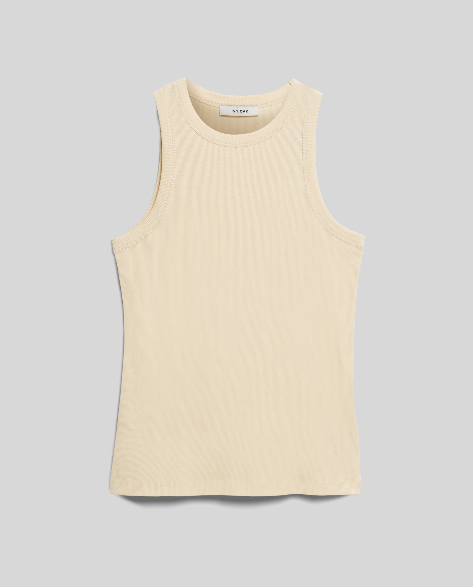 The KLARA ANN Top by IVY OAK is a comfortable, beige, sleeveless crew neck tank crafted from soft Organic Cotton, shown laid flat on a light gray background.