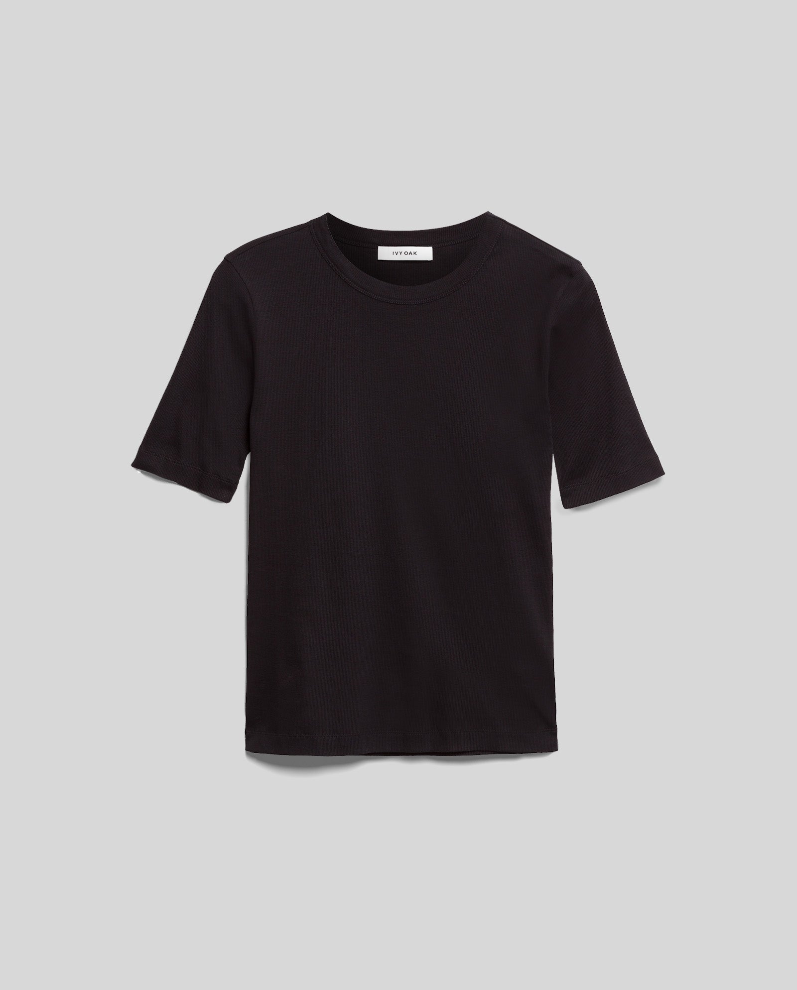 The IVY OAK KRISTIN Top is a comfortable, plain black short-sleeve tee made from Organic Cotton, shown on a light gray background.
