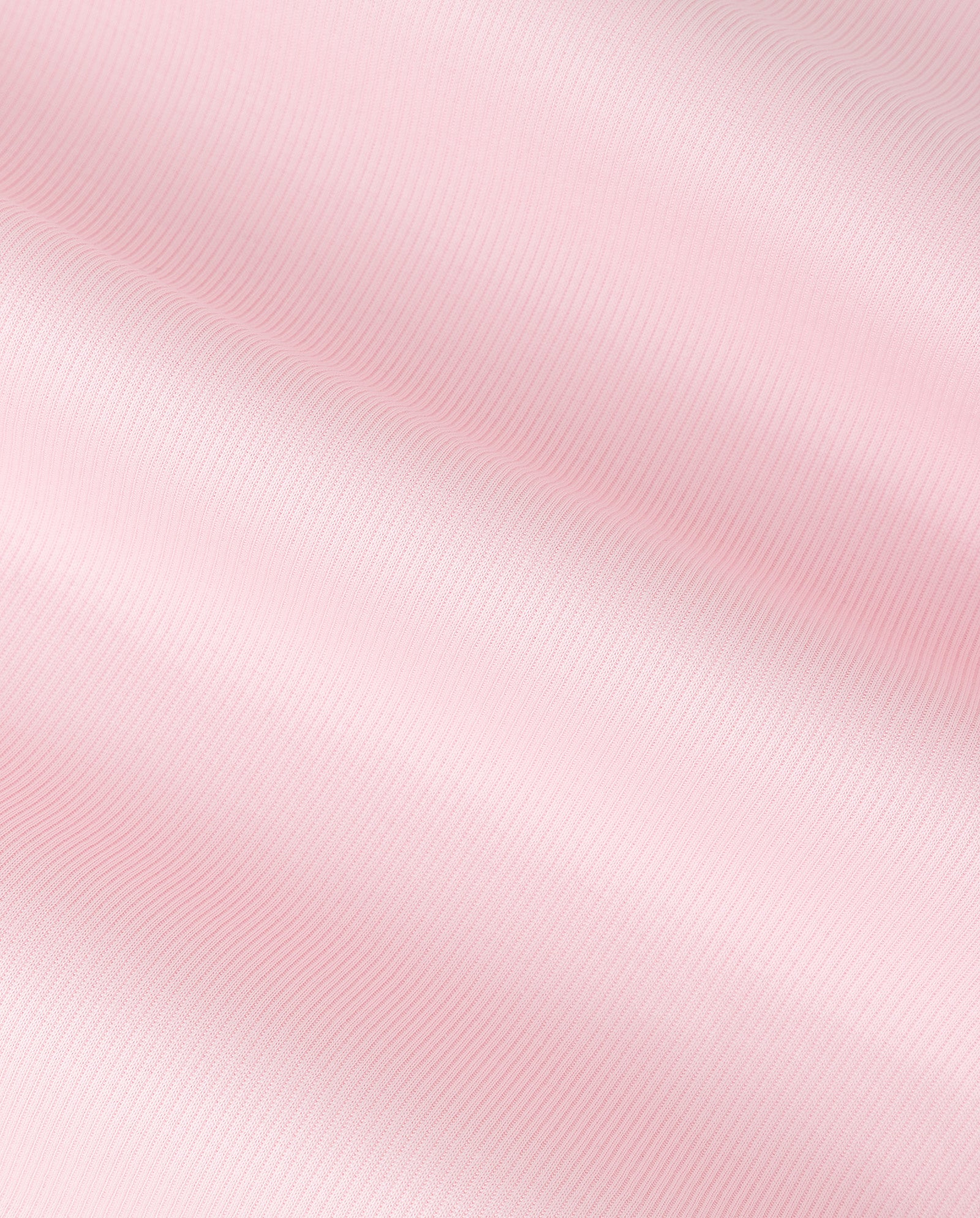 Soft pink satin fabric with gentle diagonal folds and a subtle, shiny texture, reminiscent of the comfortable elegance found in the IVY OAK KRISTIN Top made from organic cotton.