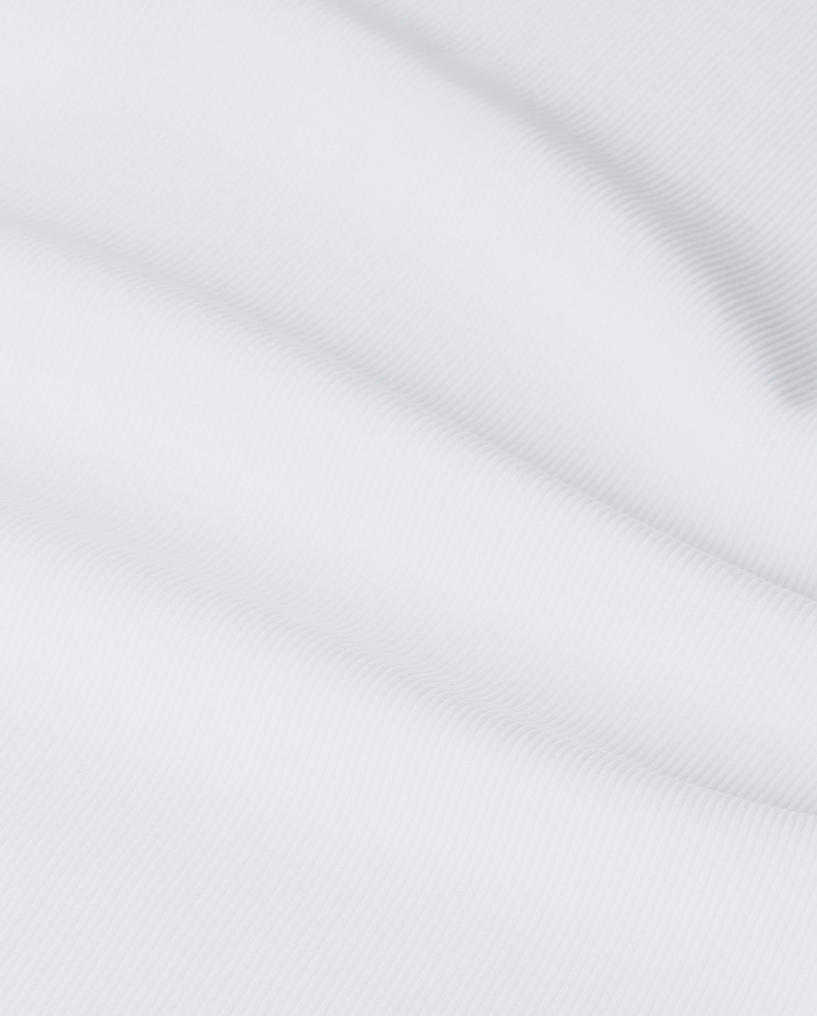 Close-up of smooth, white Organic Cotton fabric with subtle diagonal lines and gentle folds, offering a comfortable feel—perfect for the KRISTIN Top by IVY OAK.