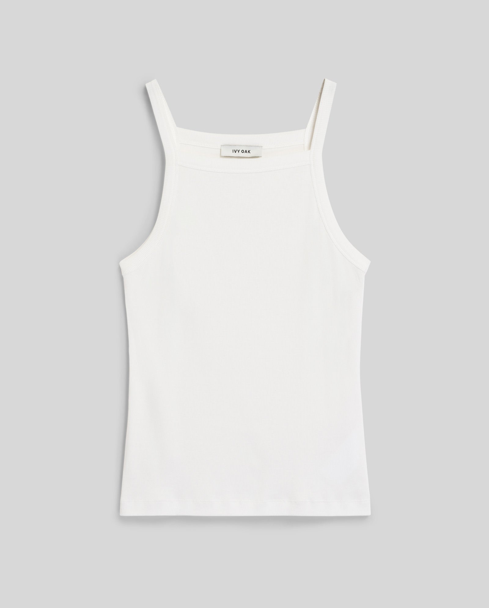 The IVY OAK KLARA ROSE Top is a white sleeveless tank with a ripp-optic texture, square neckline, and slim shoulder straps, displayed on a light gray background.