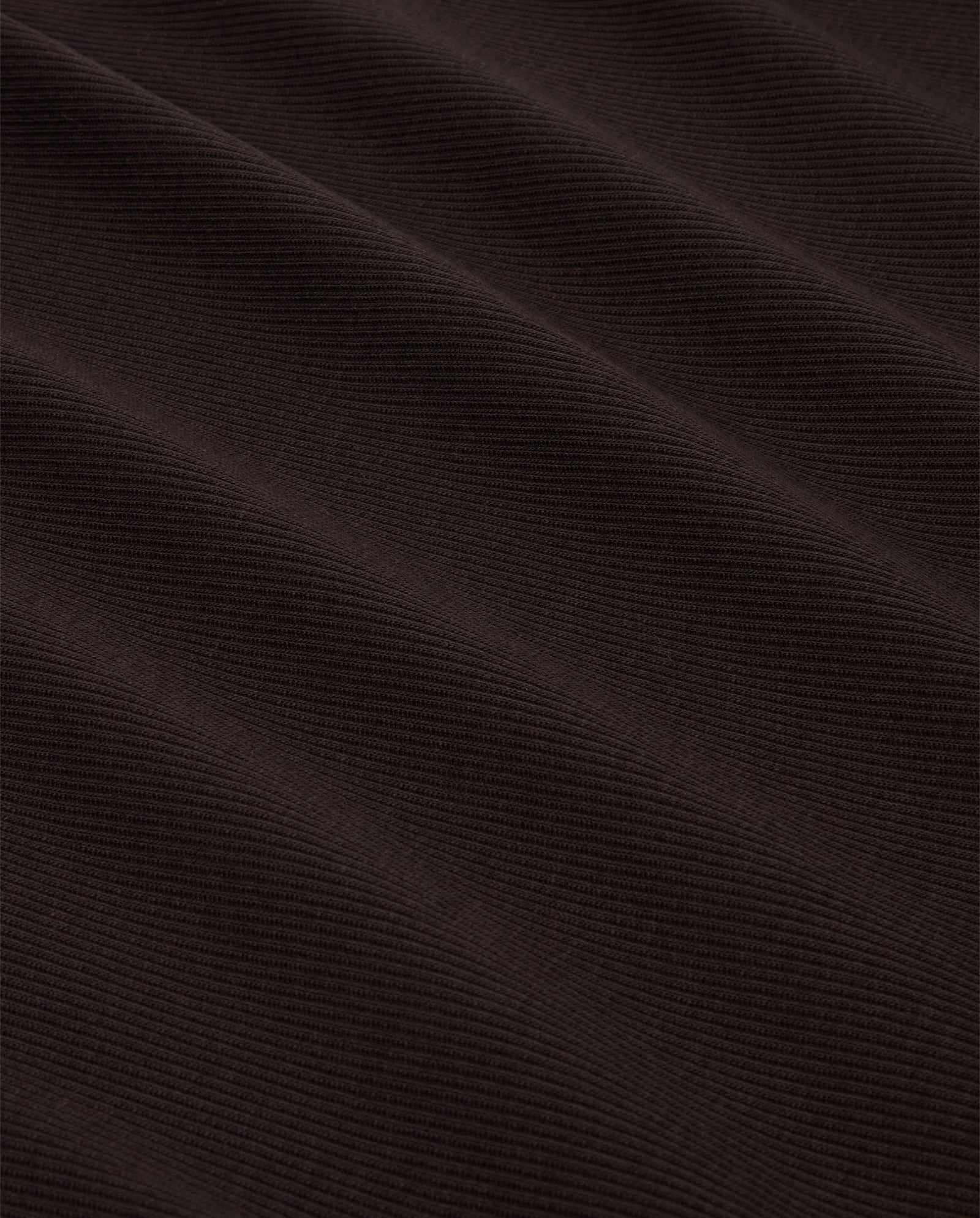 Close-up of the FINLEY Top by IVY OAK in dark brown ribbed knit with diagonal lines and a soft, textured look—ideal for a cozy tank top or sleeveless style.