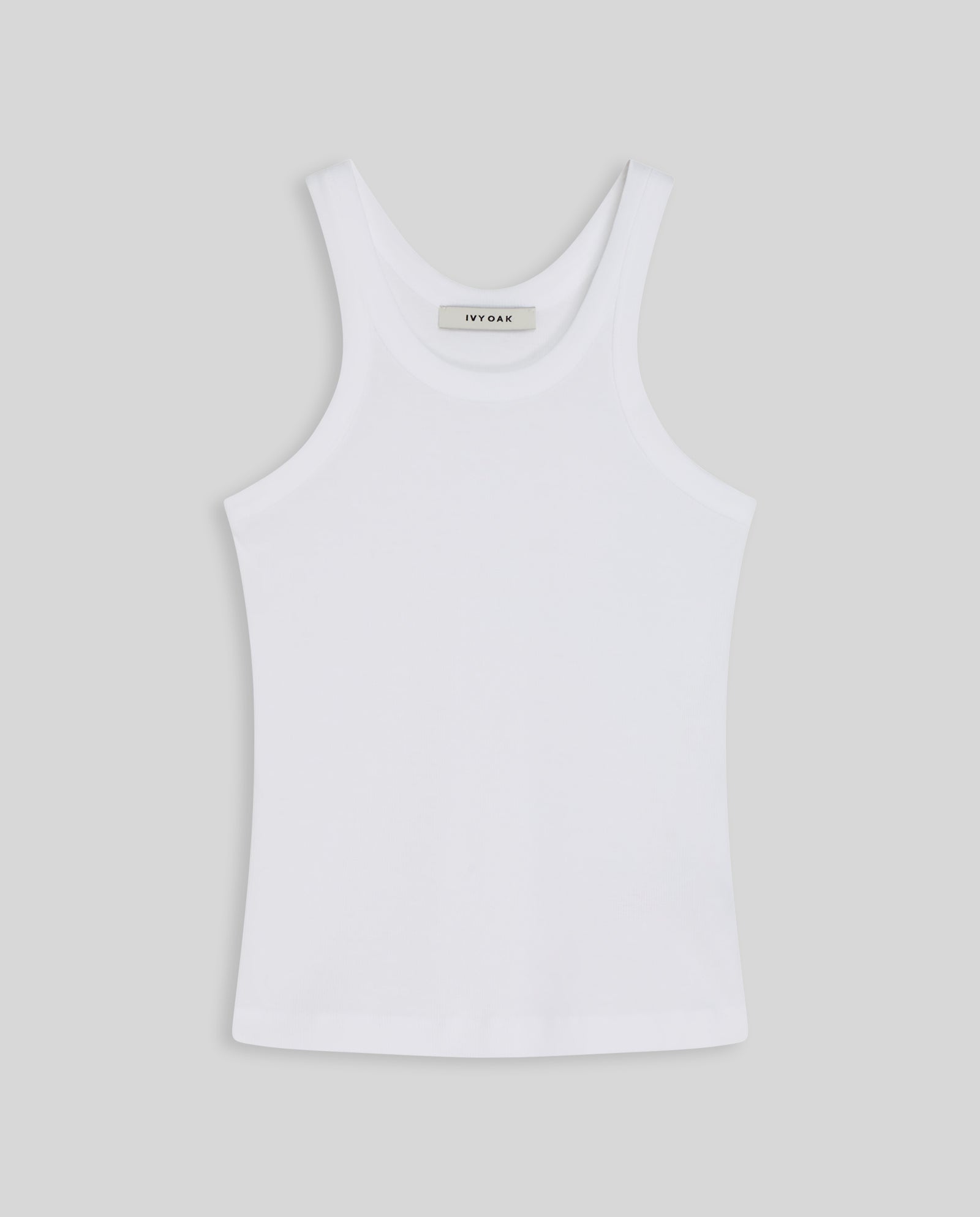 The IVY OAK FINLEY Top is a white womens sleeveless ribbed knit tank, shown laid flat on a light grey background.