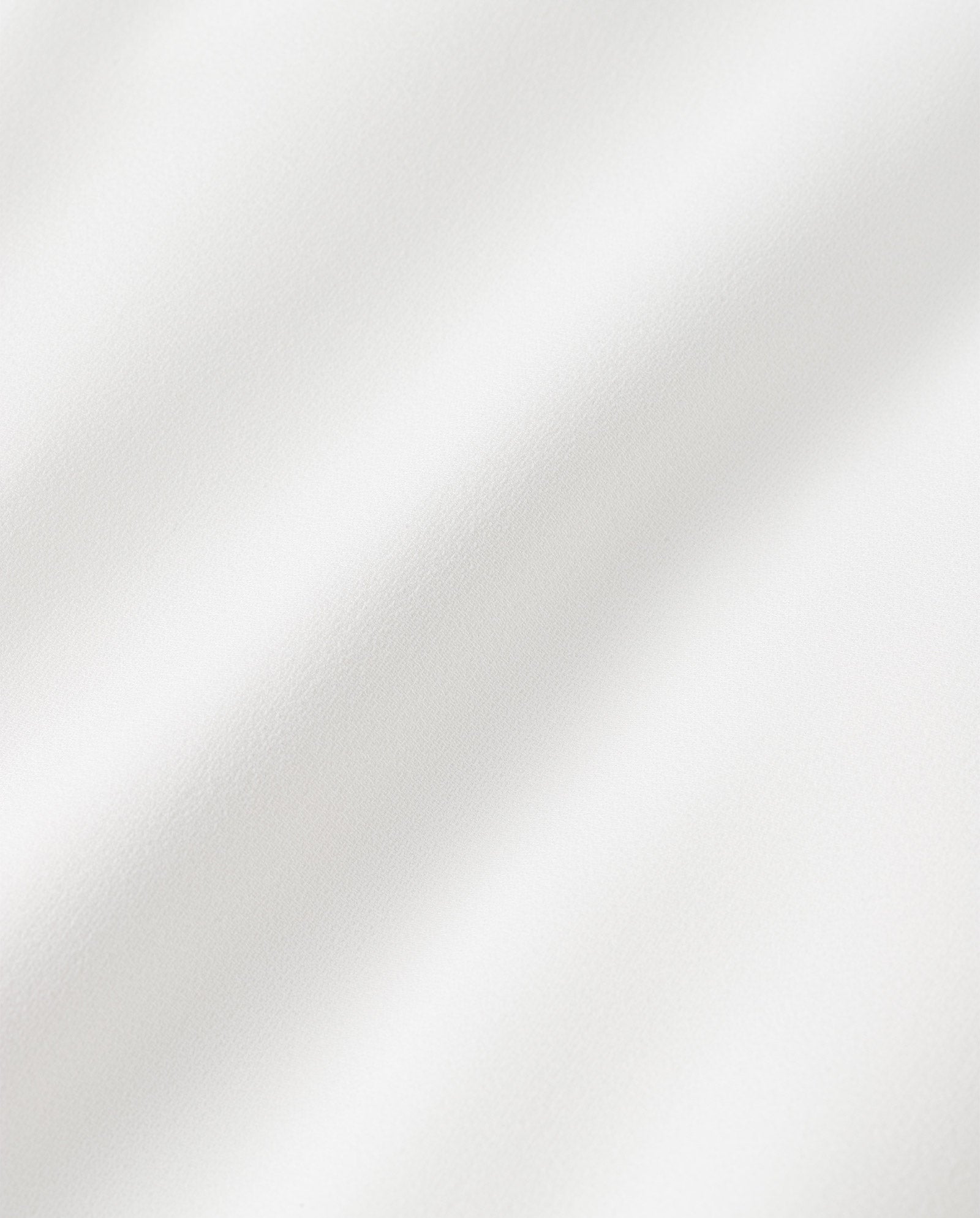 Close-up of the SIRENA Bridal Skirt by IVY OAK, showcasing its white fabric with soft folds and smooth texture—perfect for a customizable maxi-length design.