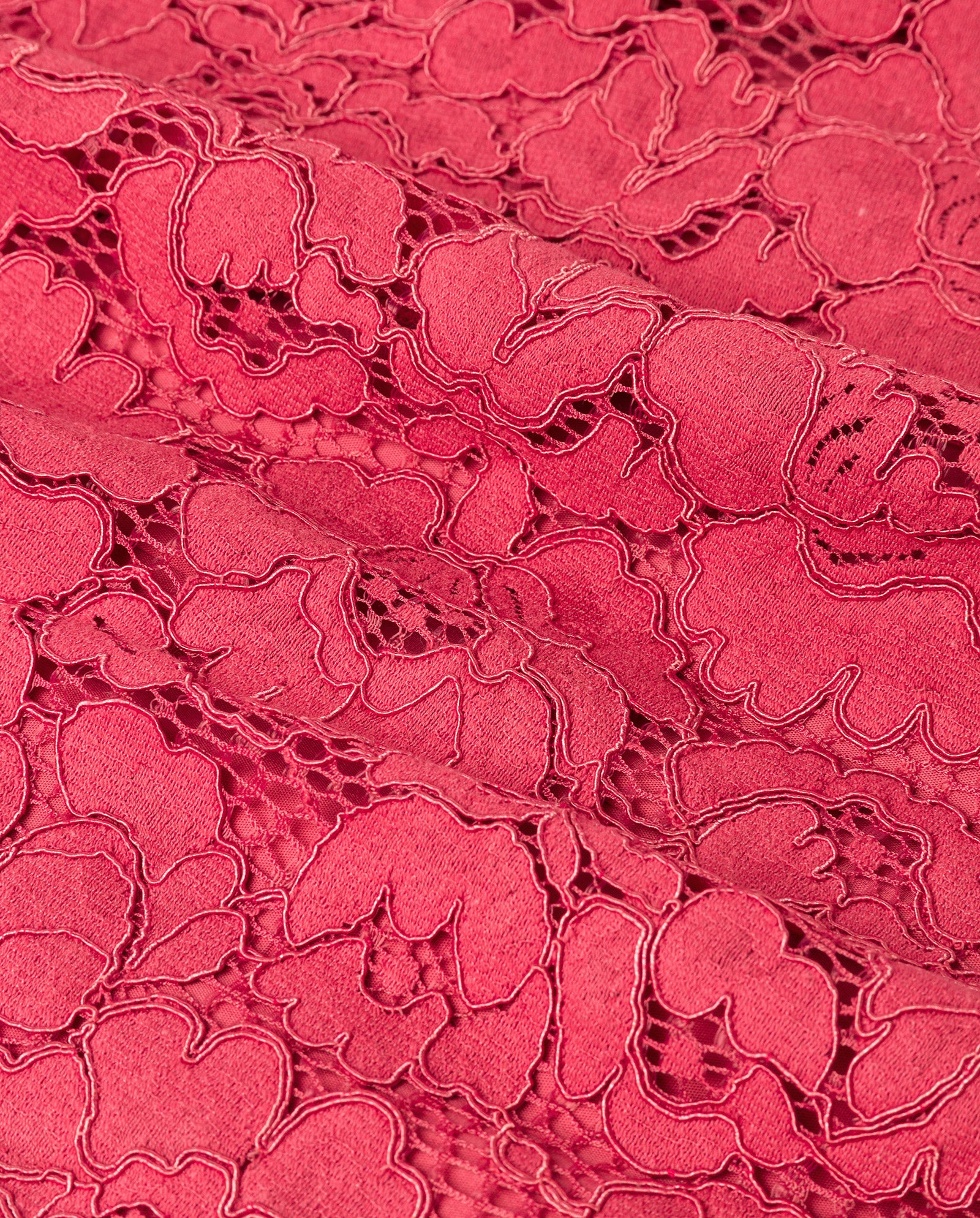 Close-up of the MARA Dress by IVY OAK, featuring textured pink lace fabric with a floral pattern and delicate embroidered details.