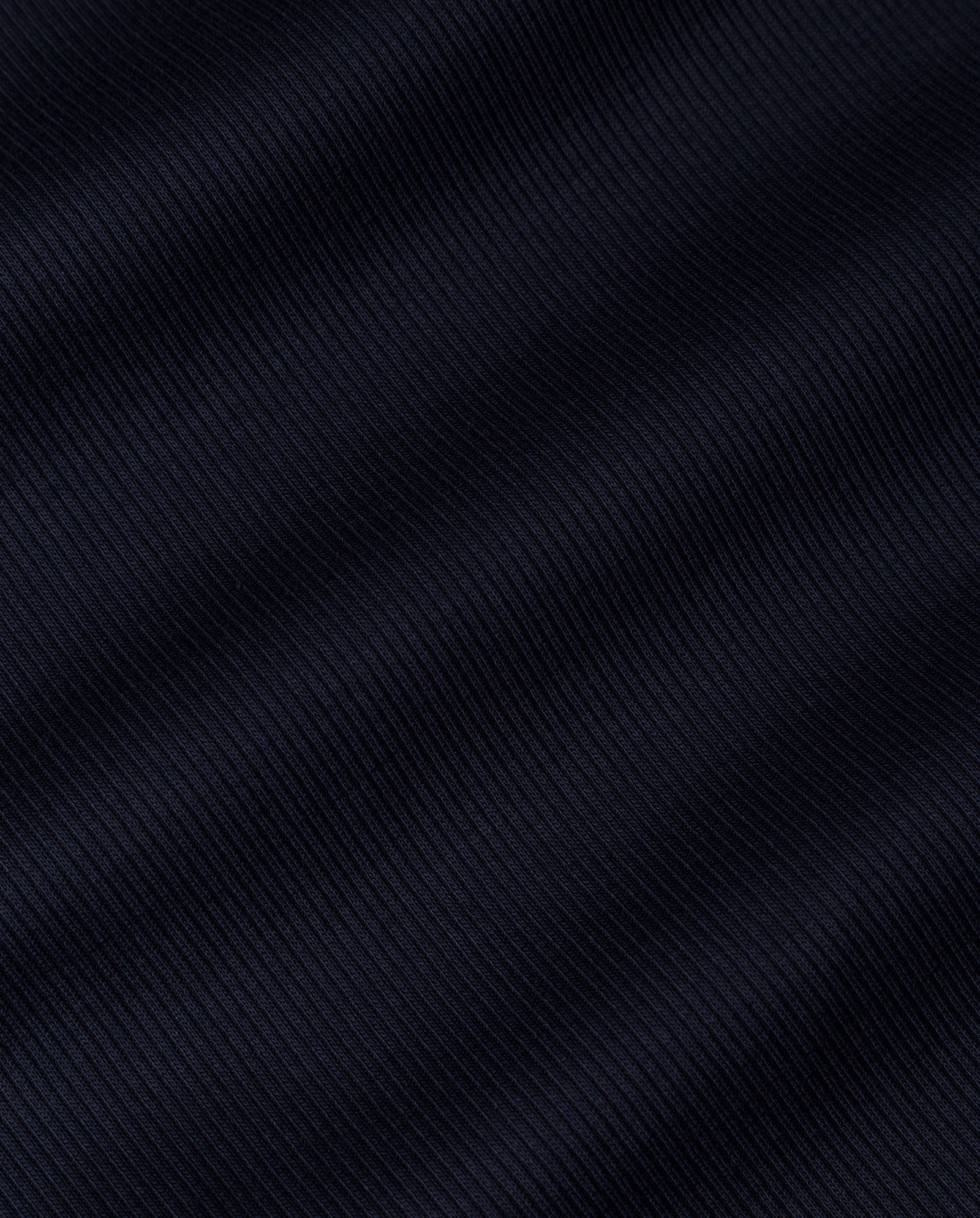 Close-up of the dark, ribbed knit fabric with diagonal textured lines and subtle waves, highlighting the elegance of the IVY OAK KRISTYNA Dress.