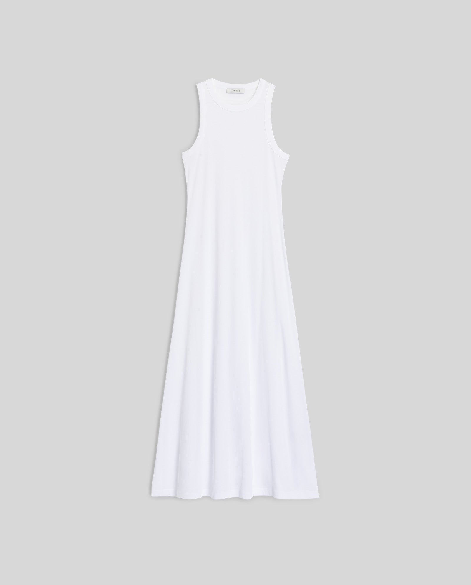 Sleeveless white KRISTYNA Dress by IVY OAK featuring a ribbed knit bodice and flared hem, shown on a plain gray background.