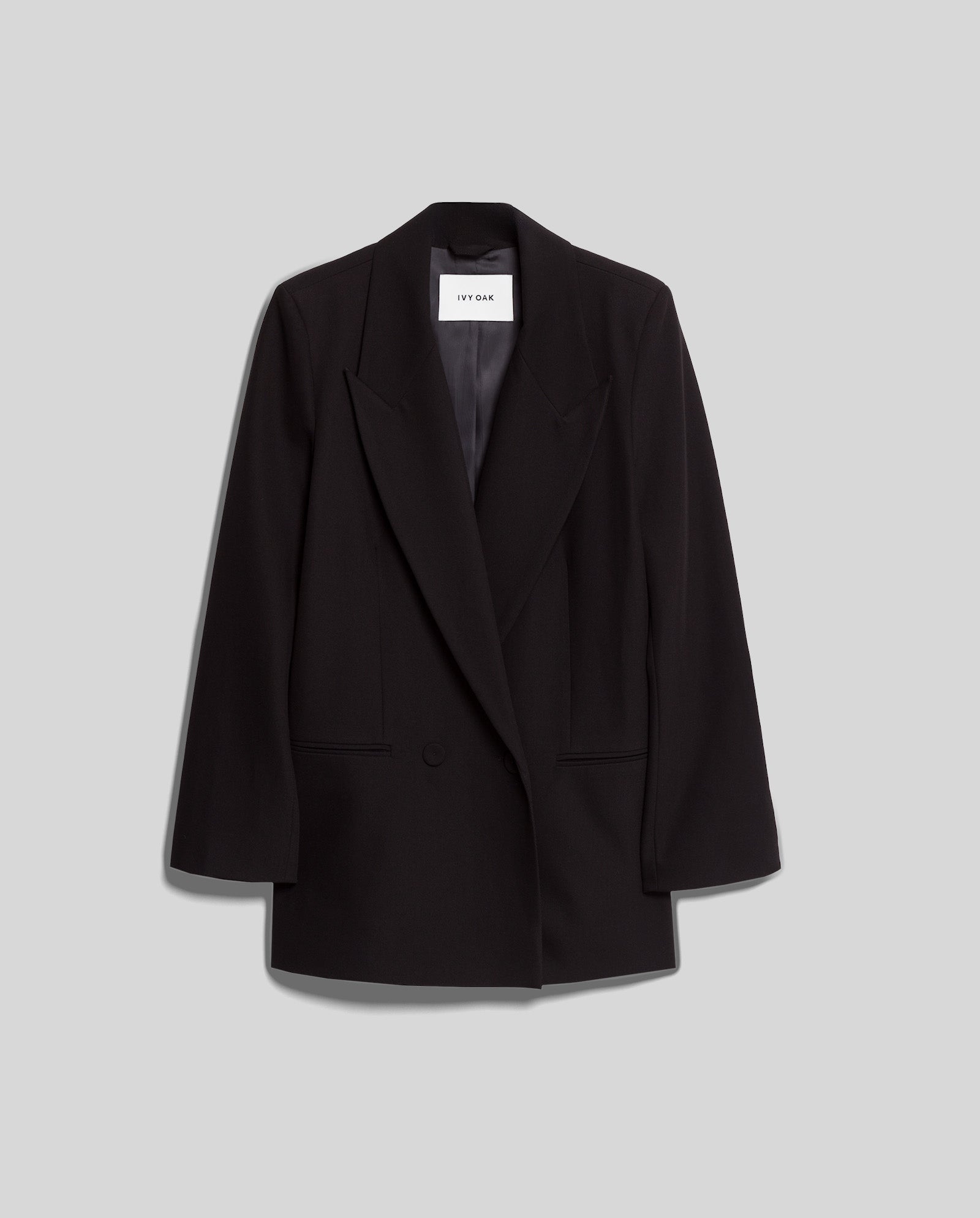 The IVY OAK JIL Blazer is a black tailored tuxedo jacket featuring a single button and peak lapel, shown against a plain light gray background.