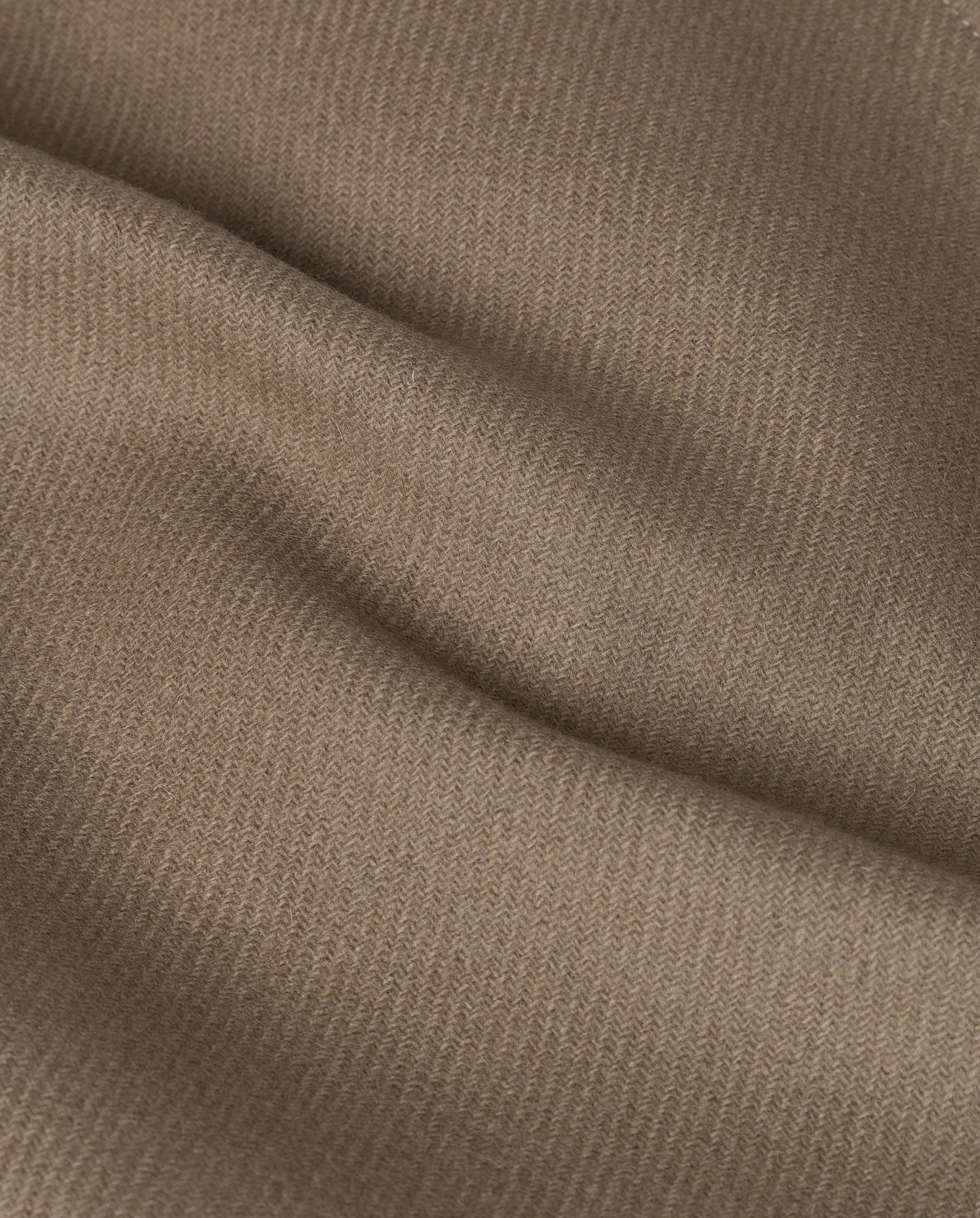 Close-up of the CARLY Pea Coat by IVY OAK, featuring light brown textured fabric with soft folds and a subtle diagonal weave, characteristic of this oversized outerwear.