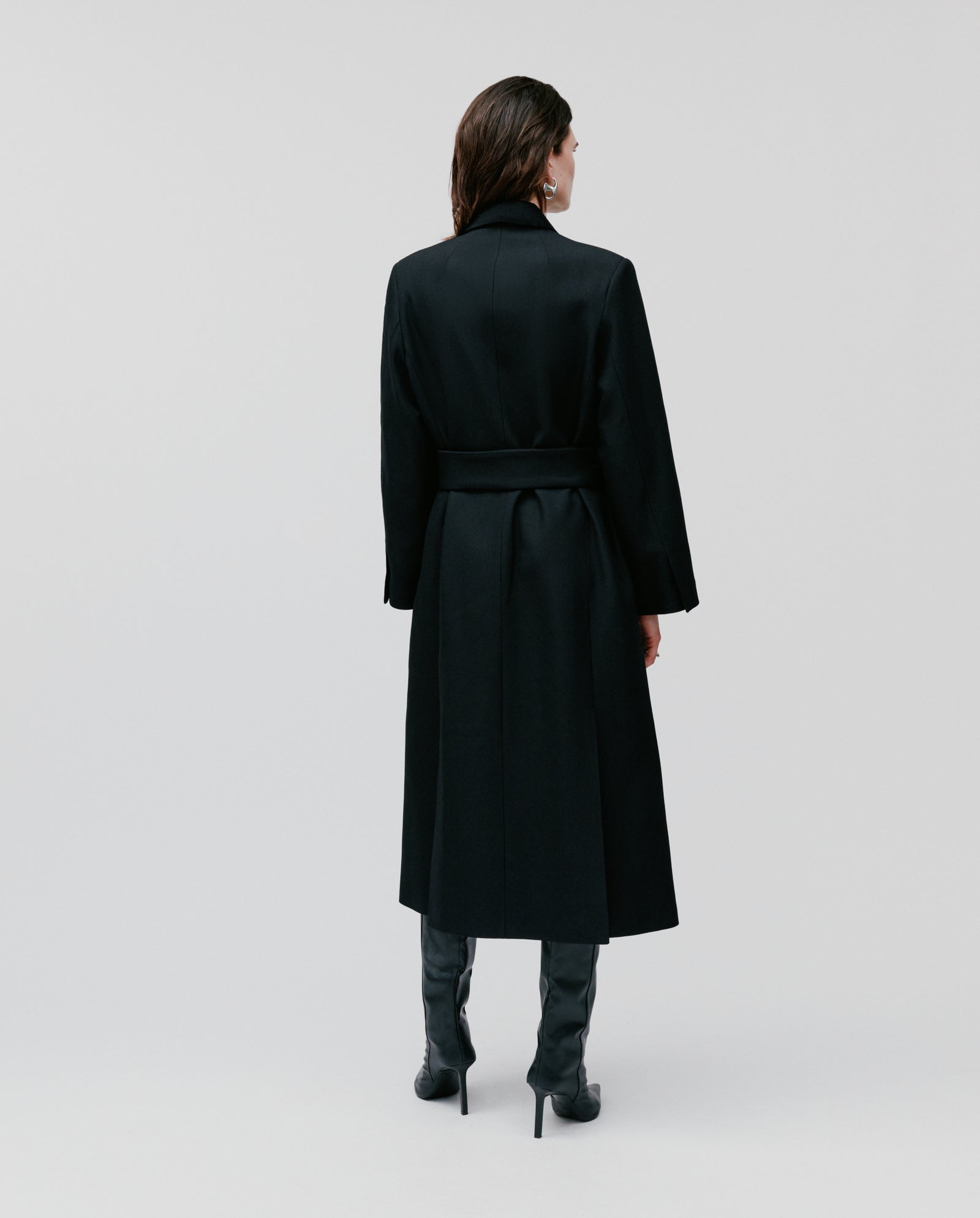 Wearing the IVY OAK CORI Coat and black boots, a person stands facing away against a plain light background.