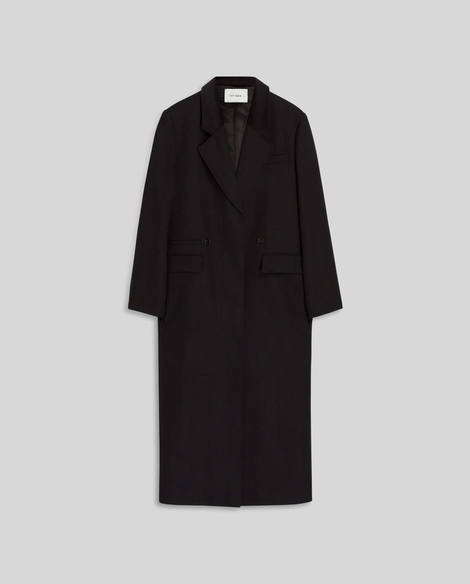 The IVY OAK CORI Coat is a long black double-breasted blazer with a velvet collar and two front pockets, shown on a light gray background.
