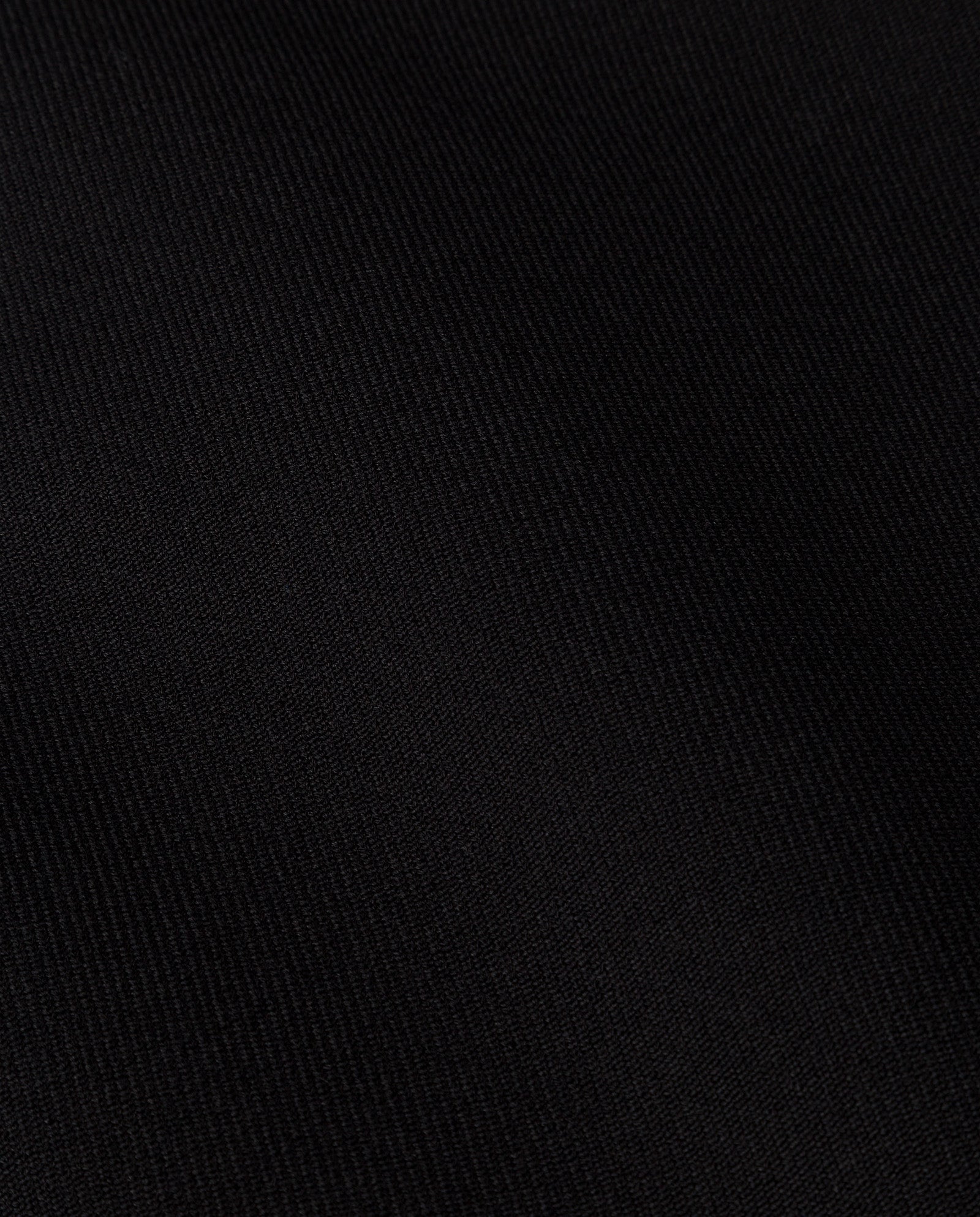 Close-up of the black CORI ANN Vest by IVY OAK, showcasing its subtle diagonal ribbed texture, reminiscent of a classic blazer waistcoat.