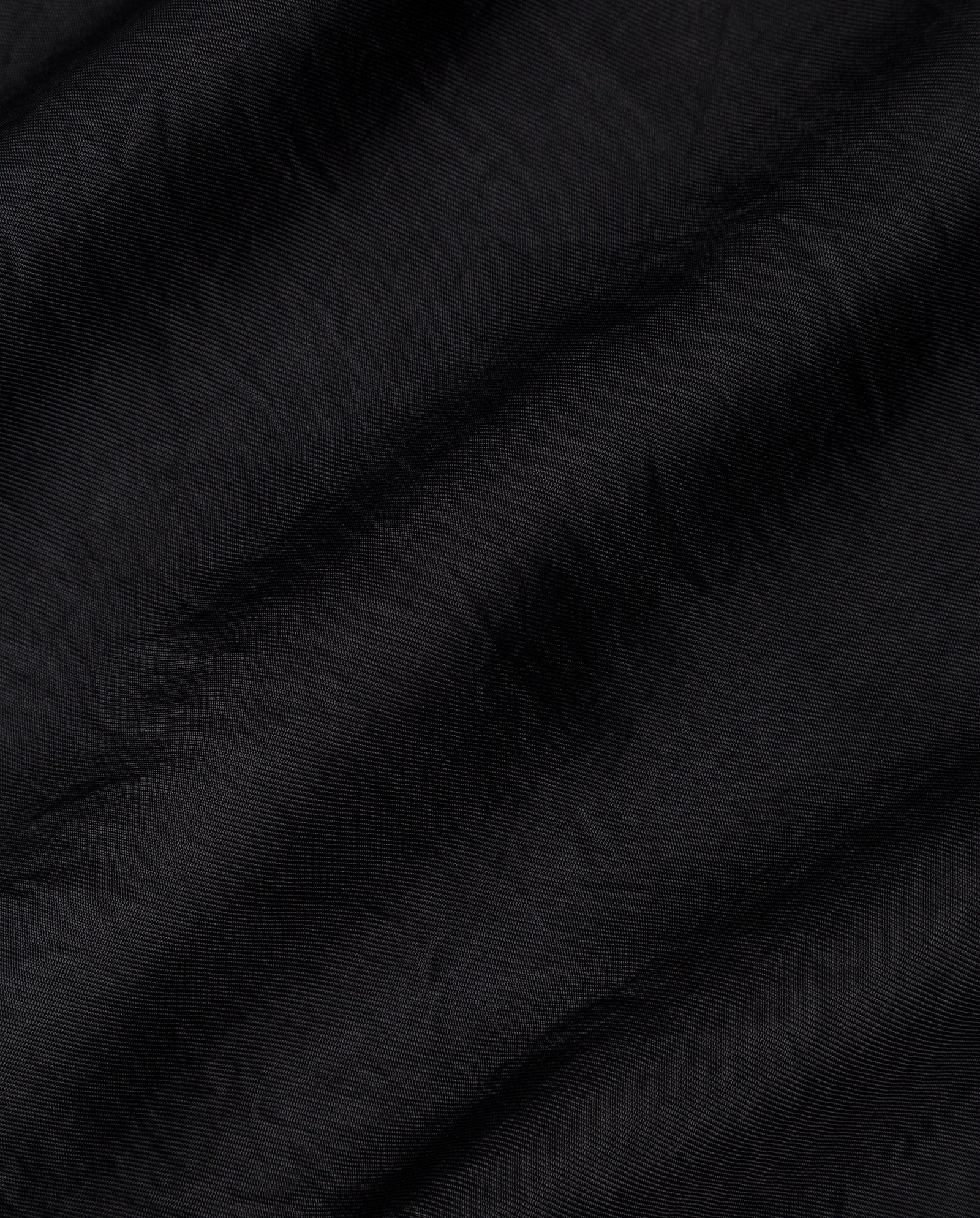 The ELOISE Top by IVY OAK features black organza fabric with soft folds and a subtly shiny finish.