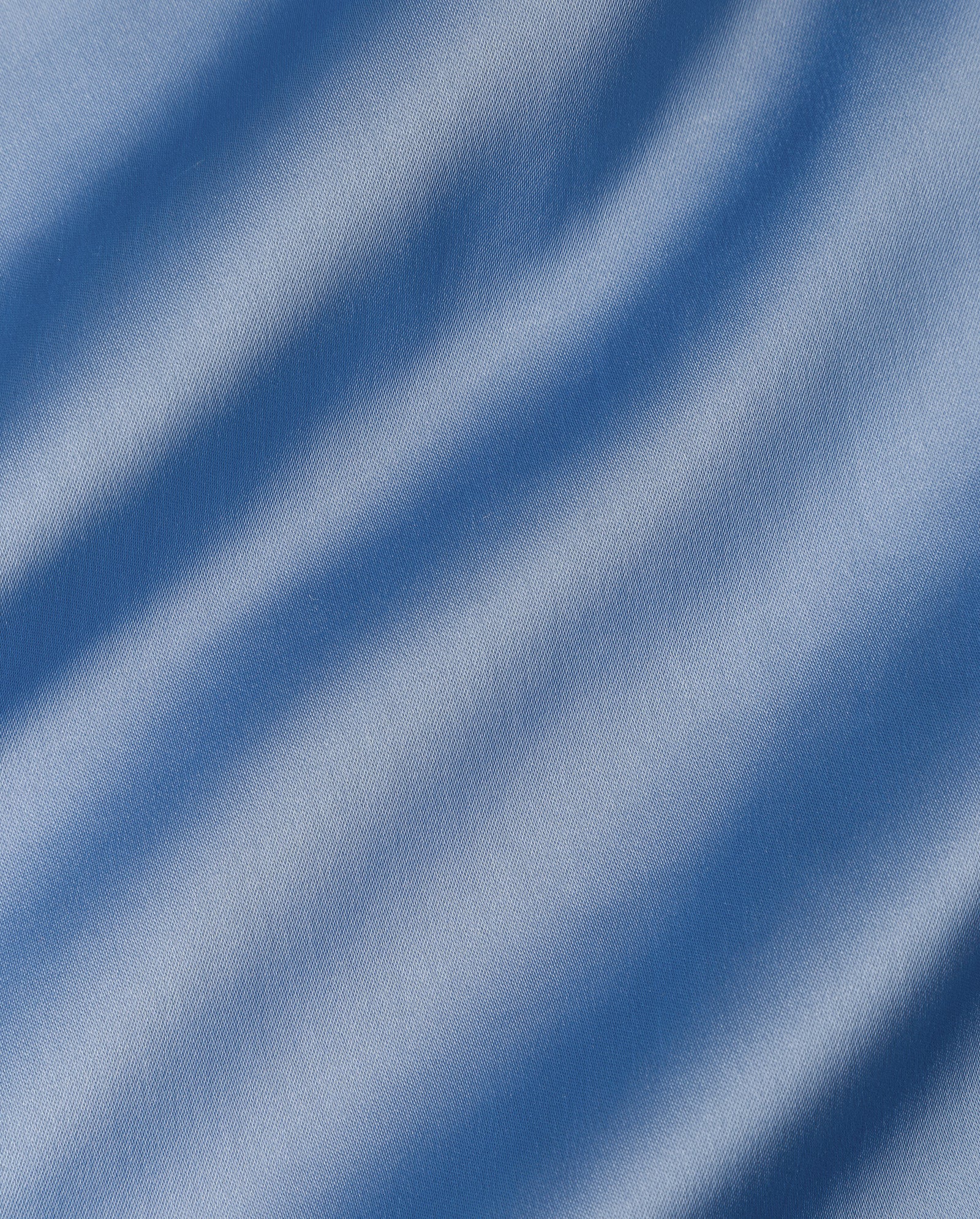 The IVY OAK TILDA ANN Straptop features smooth, light blue Naia acetate fabric with soft diagonal folds that create gentle shadows and highlights.