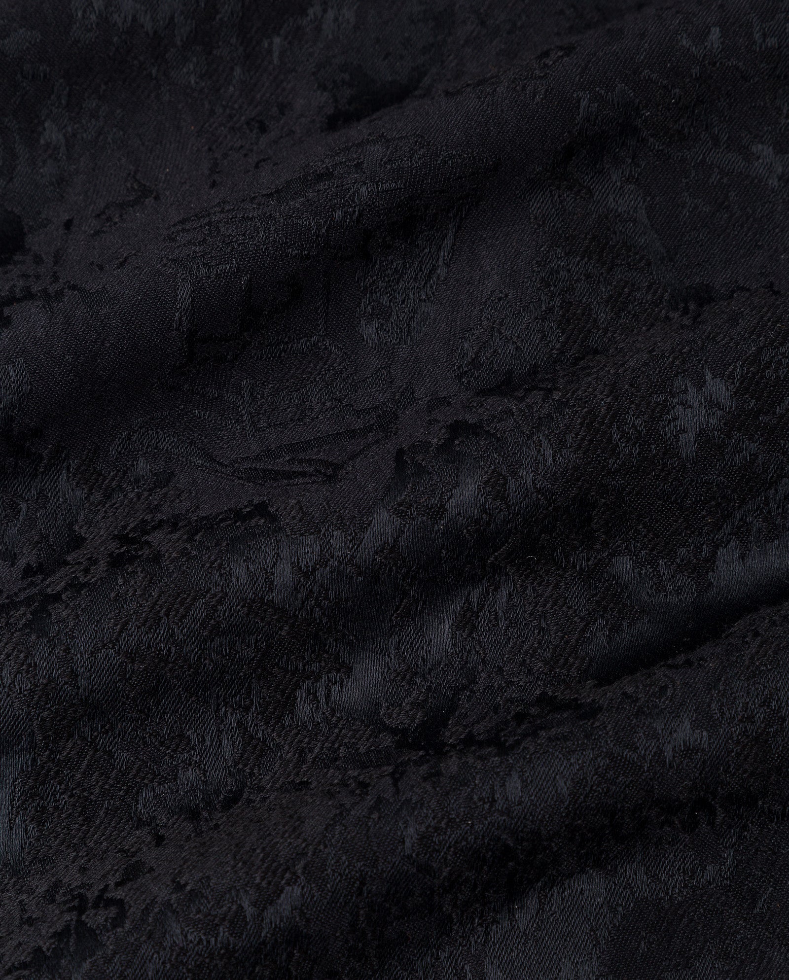 Close-up of the ELISABETH Top by IVY OAK, featuring black jacquard fabric with a subtle floral and wavy pattern—perfect for elegant blouses or puff sleeves.