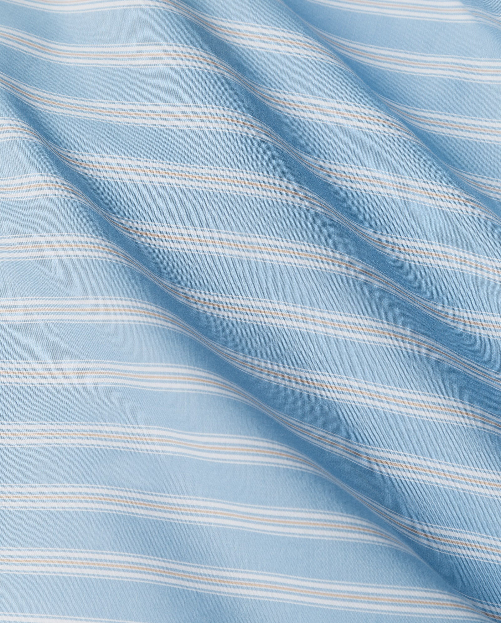 Soft light blue fabric with thin white horizontal stripes and gentle folds, ideal for making the IVY OAK BRITTNEY Blouse in a relaxed boxy fit.