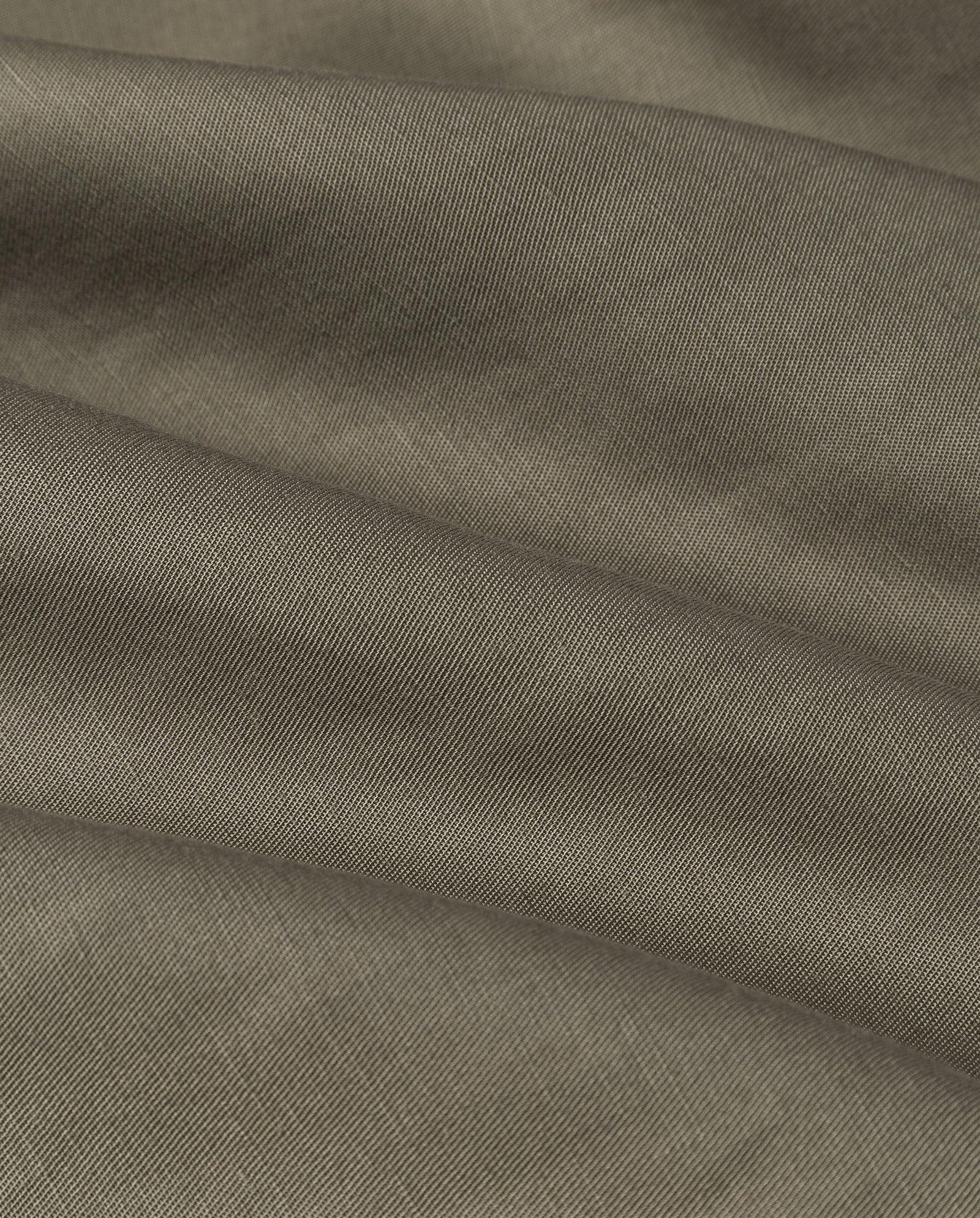 Close-up of the TALA ANN Top by IVY OAK, featuring olive green linen-blend fabric with a visible diagonal weave and soft folds.
