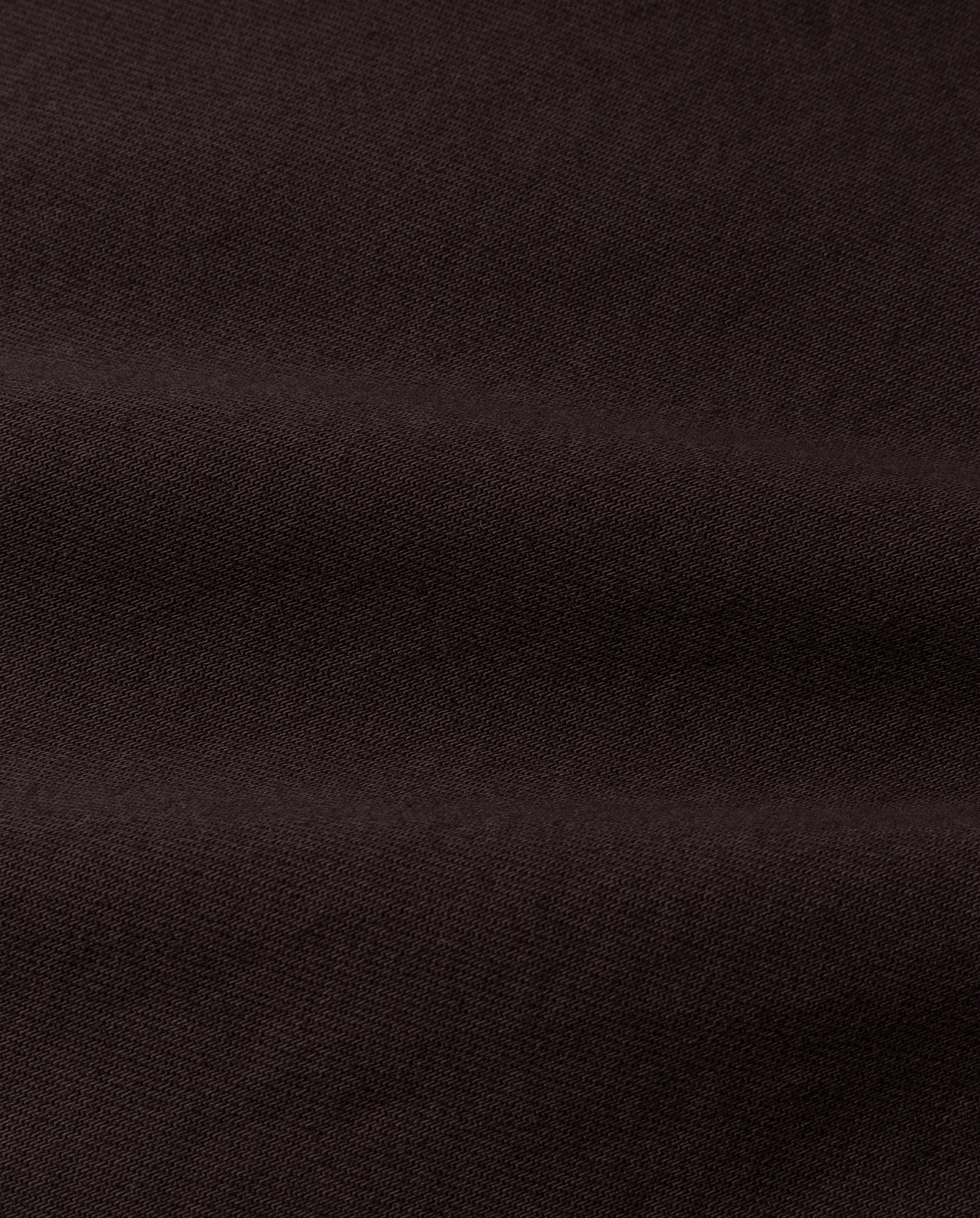 The ELMA Blouse by IVY OAK features dark brown fabric with a soft texture and subtle horizontal folds, ideal for achieving a chic peplum look.