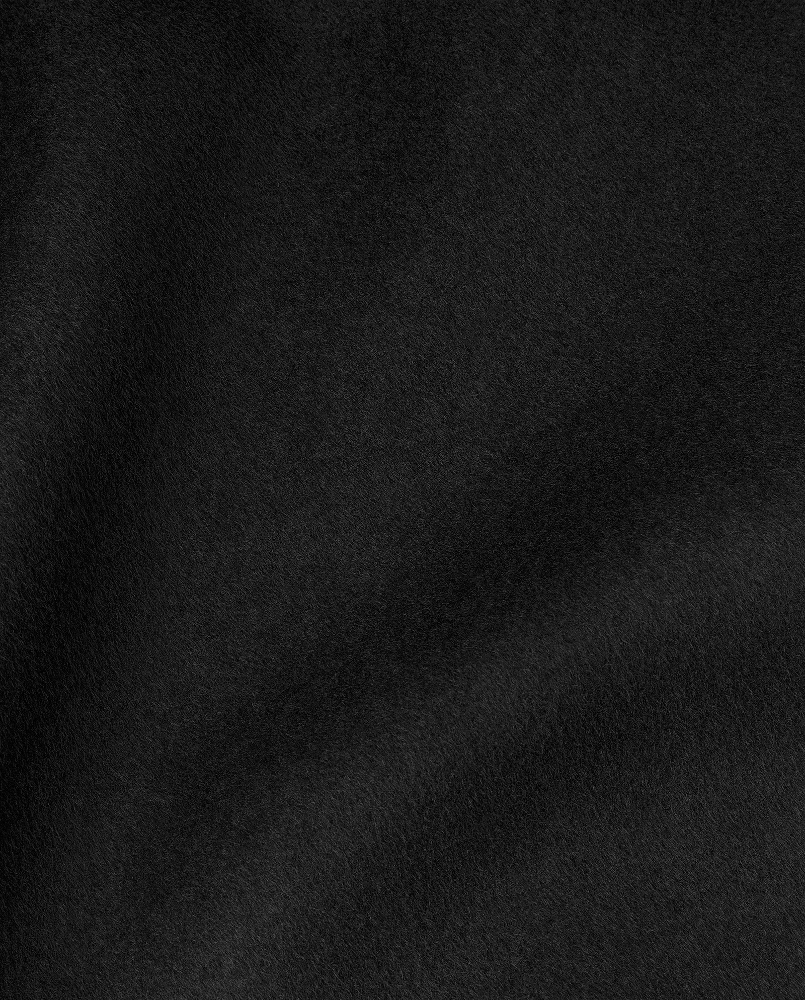 A close-up of the CELIA Doubleface Coat by IVY OAK shows its soft black wool fabric, detailed texture, and gentle folds—crafted to the Responsible Wool Standard.