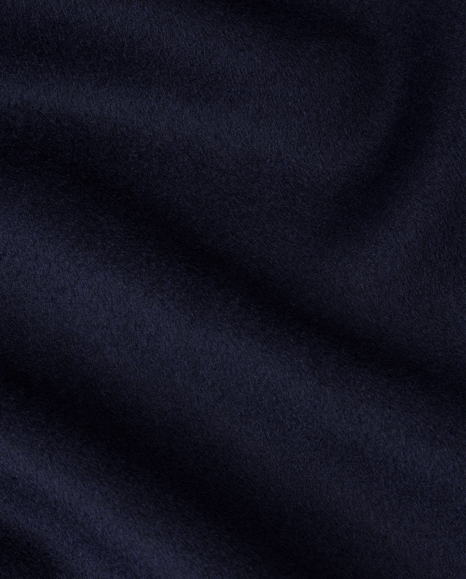 Close-up of dark navy blue fabric with a soft, smooth texture and subtle wavy folds—ideal for the IVY OAK CELIA Doubleface Coat made from Responsible Wool Standard wool.