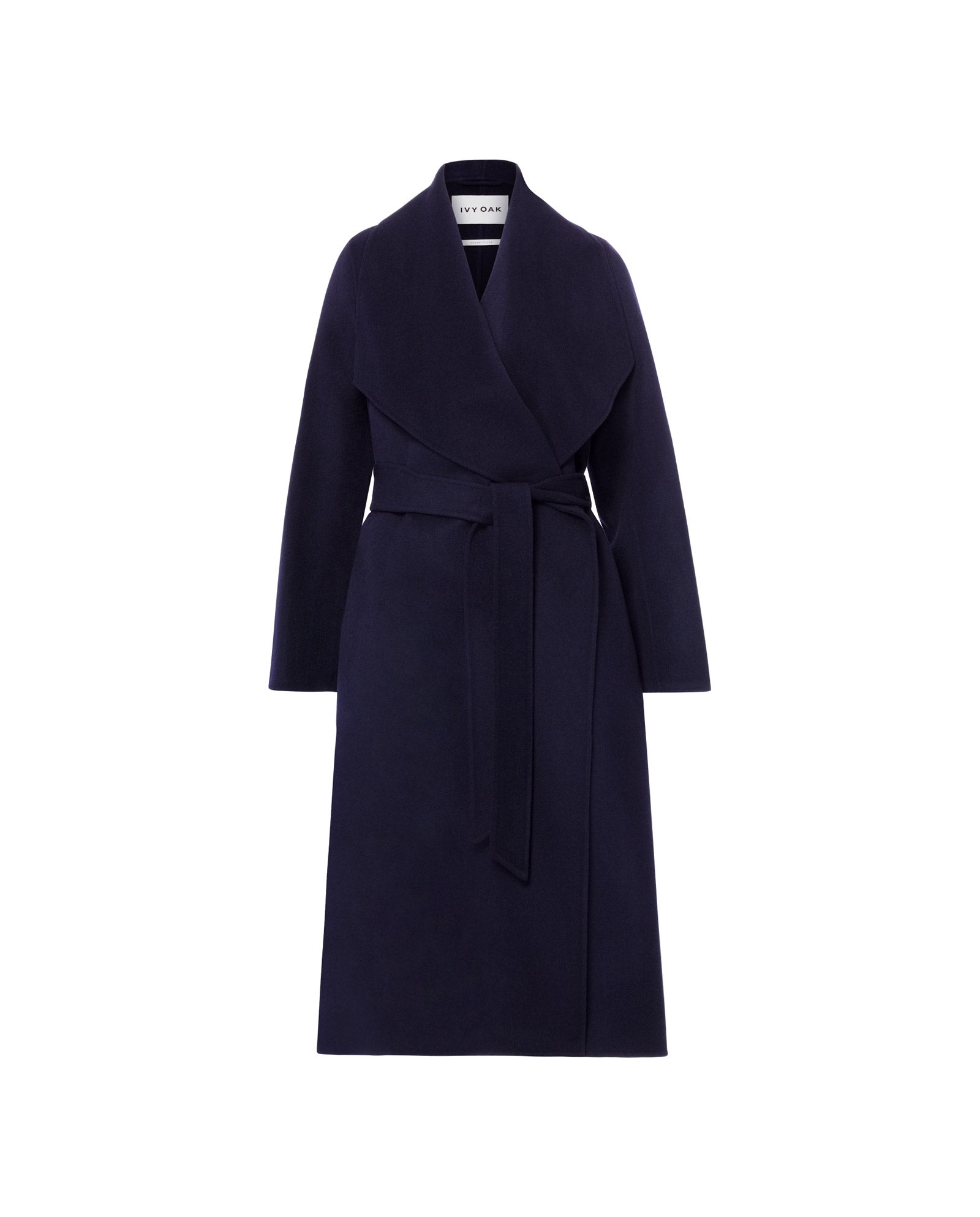 The CARRIE ROSE Wool Coat by IVY OAK features a minimalist navy design with a wide lapel collar and belted waist, made from Responsible Wool Standard certified fabric, shown on a white background.