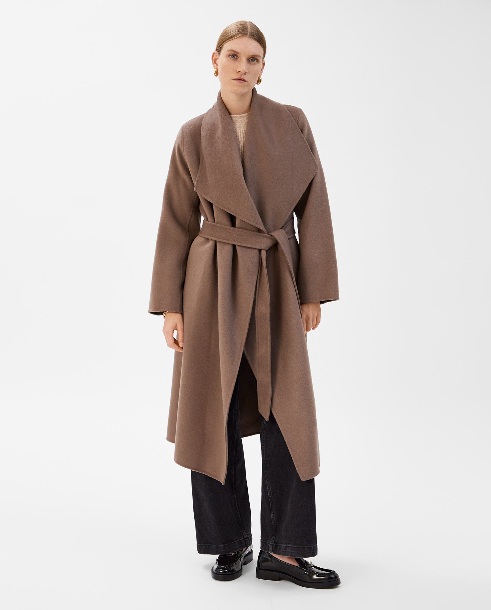 Model wears the IVY OAK CARRIE ROSE Wool Coat in brown, paired with wide-leg black pants and black shoes, standing against a white background.