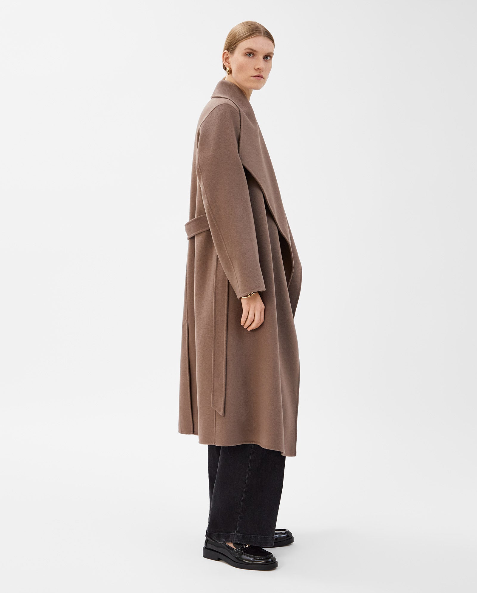 A woman wears the IVY OAK CARRIE ROSE Wool Coat, styled with black pants and shoes, standing against a plain white background.