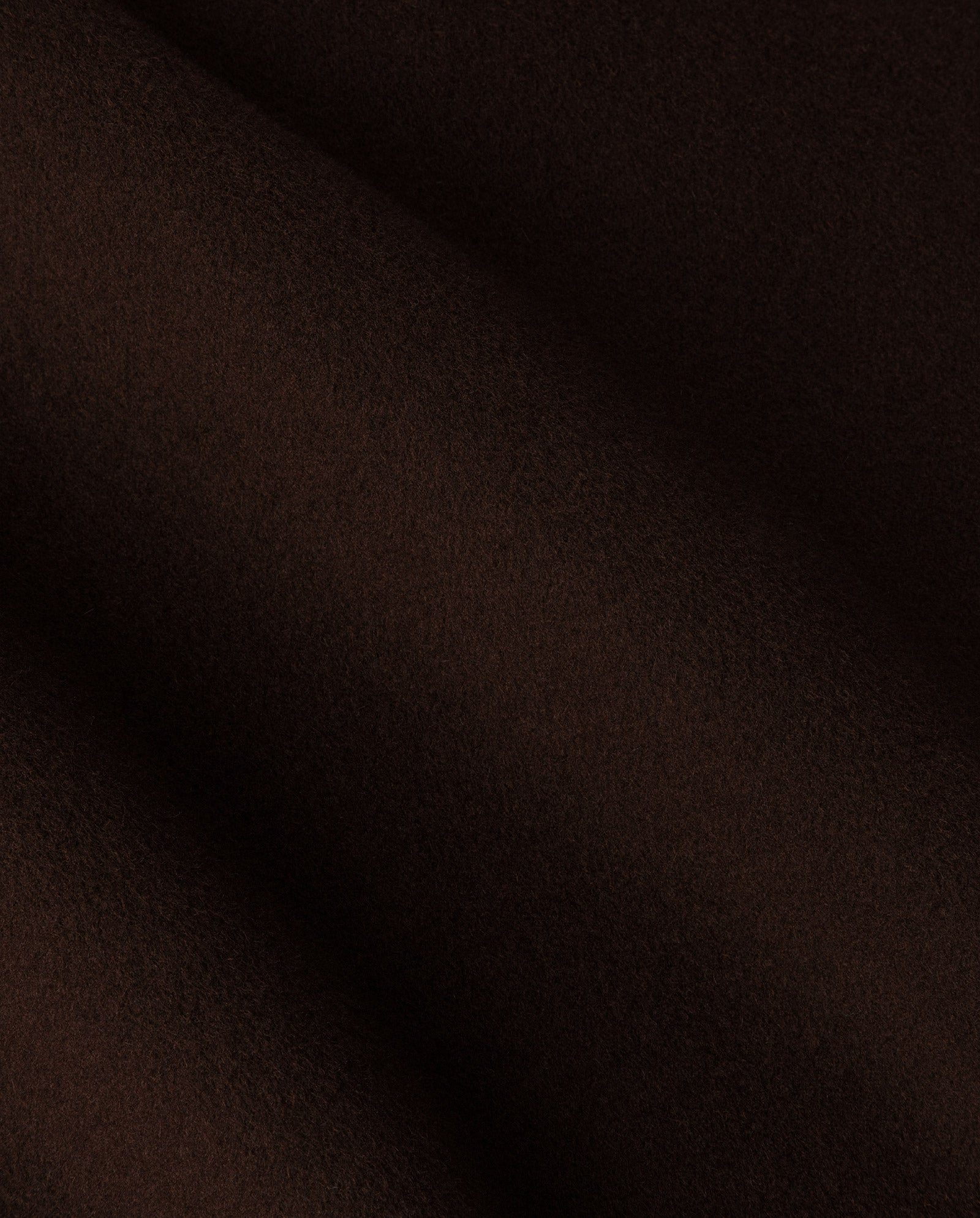 Close-up of the CELIA EDIE Coat by IVY OAK, featuring dark brown, soft, and lightly textured wool fabric with gentle folds, crafted to meet the Responsible Wool Standard.