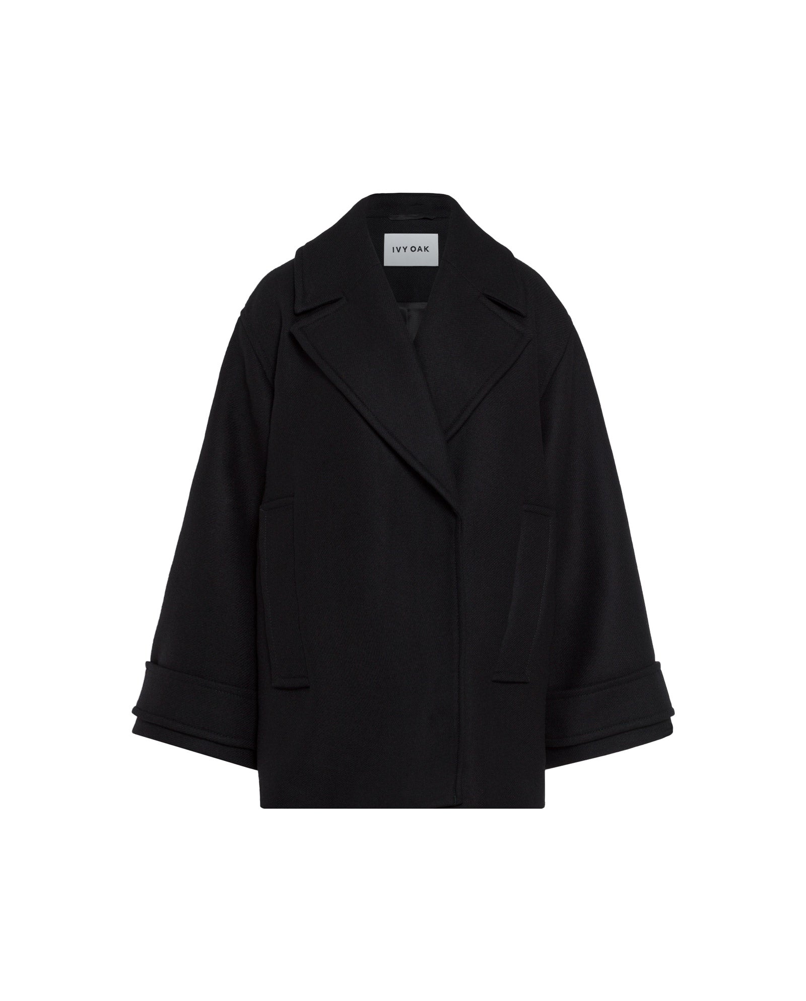 The IVY OAK CARLY Coat is a black oversized wool coat featuring a loose fit, wide lapels, cuffed sleeves, and a hidden button placket, shown on a white background.