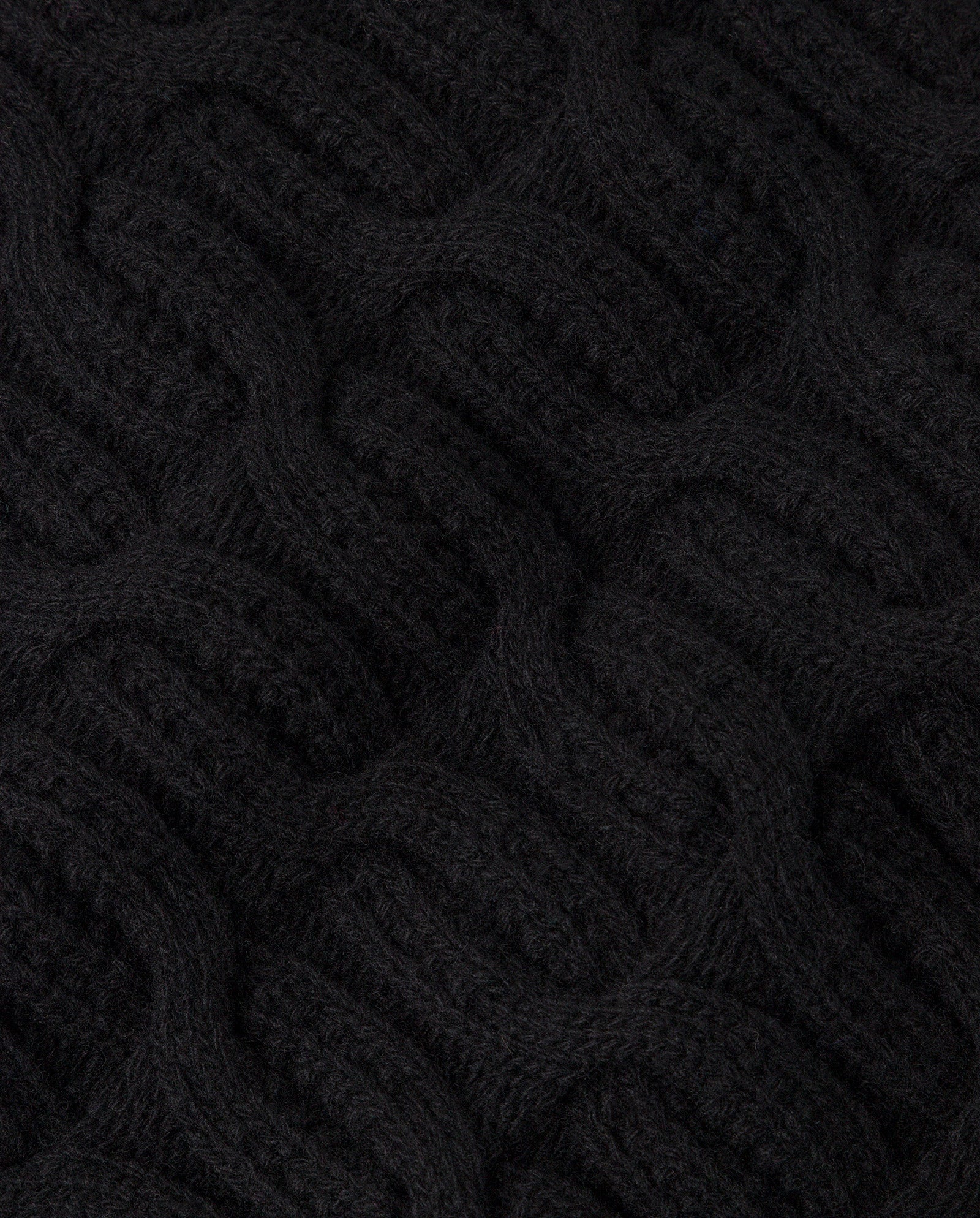 Close-up of the IVY OAK KLARISSA Pullunder, a black cable-knit sleeveless sweater crafted from extrafine merino wool.