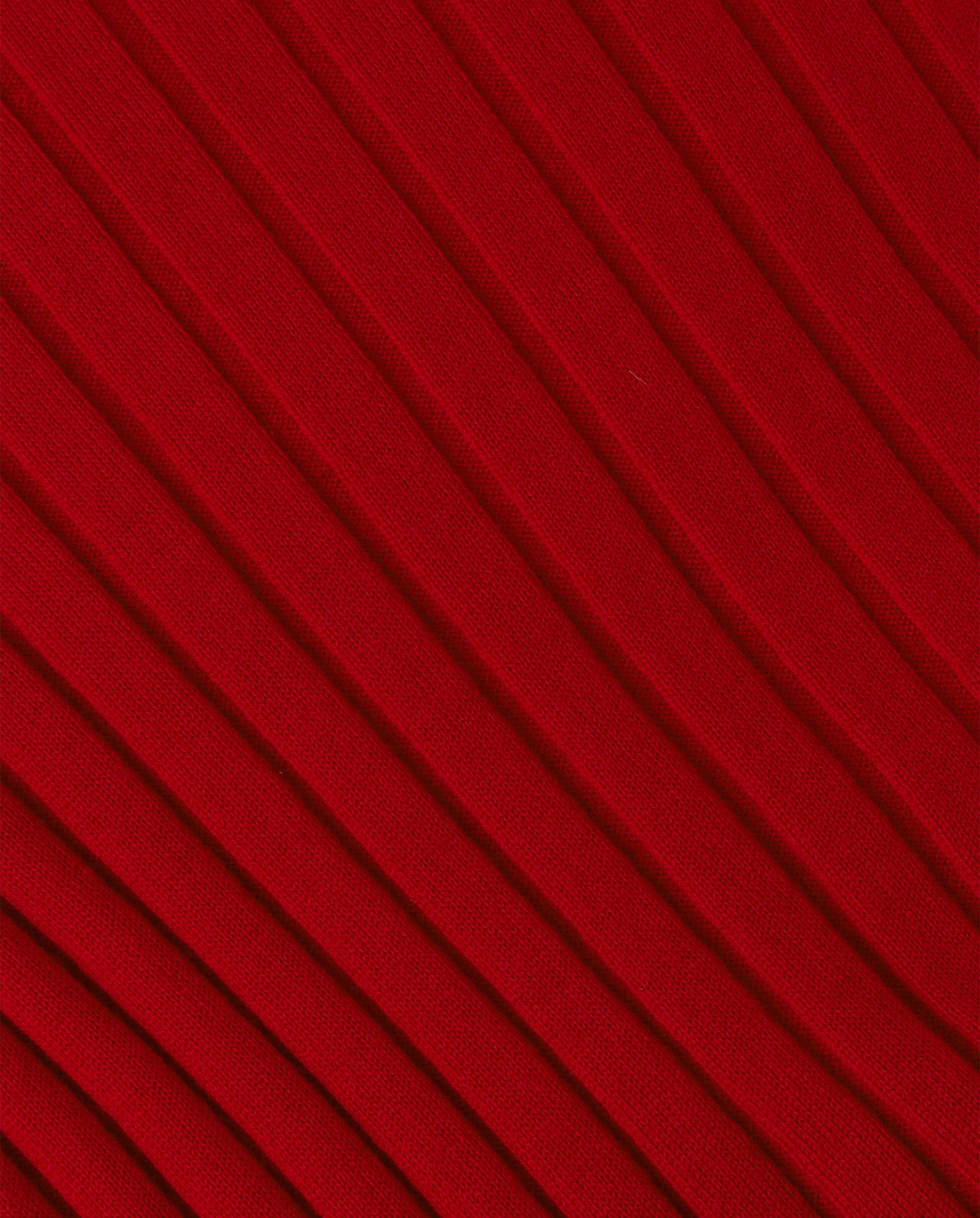 Close-up of red KACY Jumper by IVY OAK, showing its fabric with diagonal ribbed texture.