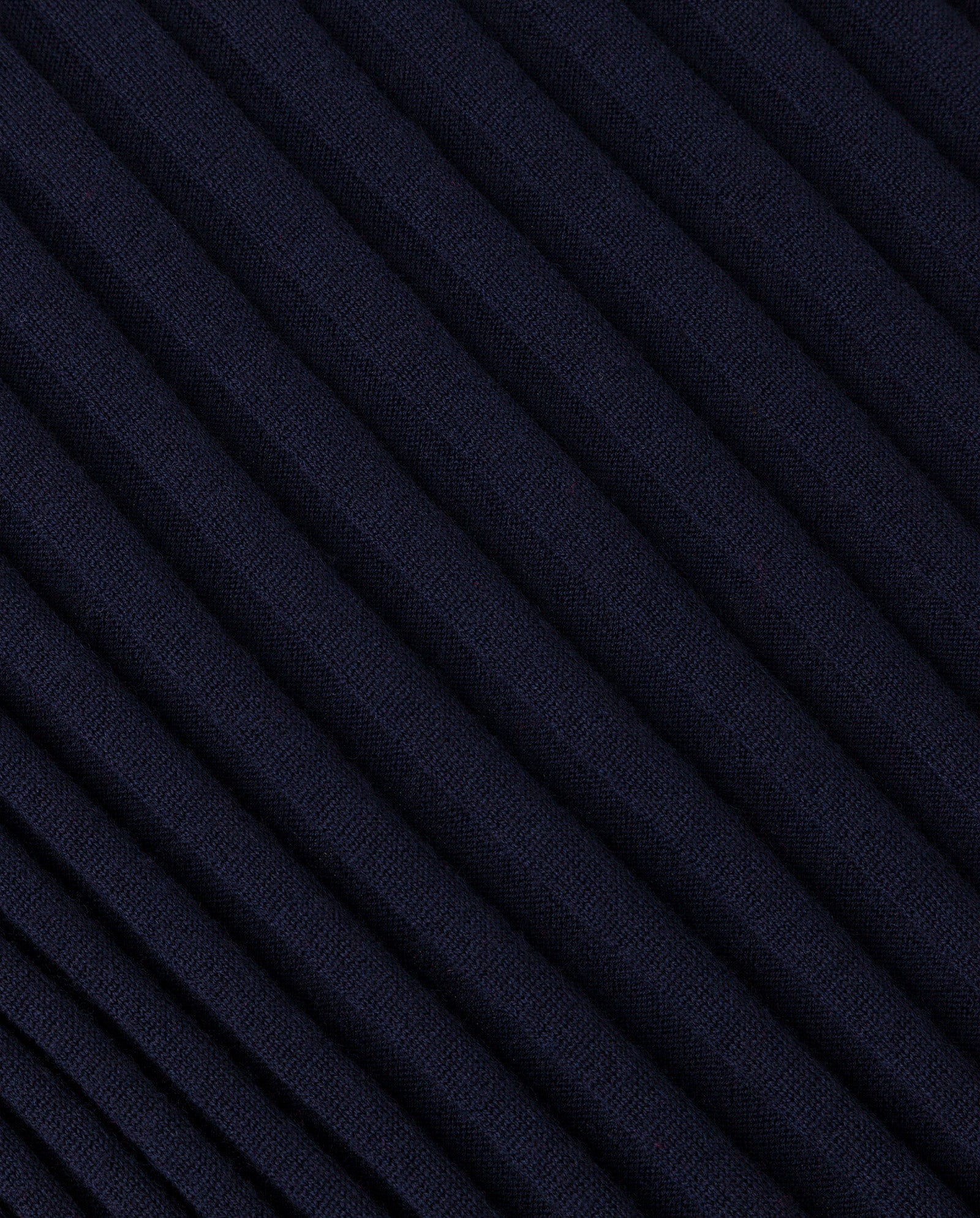 Close-up of dark blue ribbed merino wool fabric with diagonal textured lines, featured on the IVY OAK KALI Skirt.