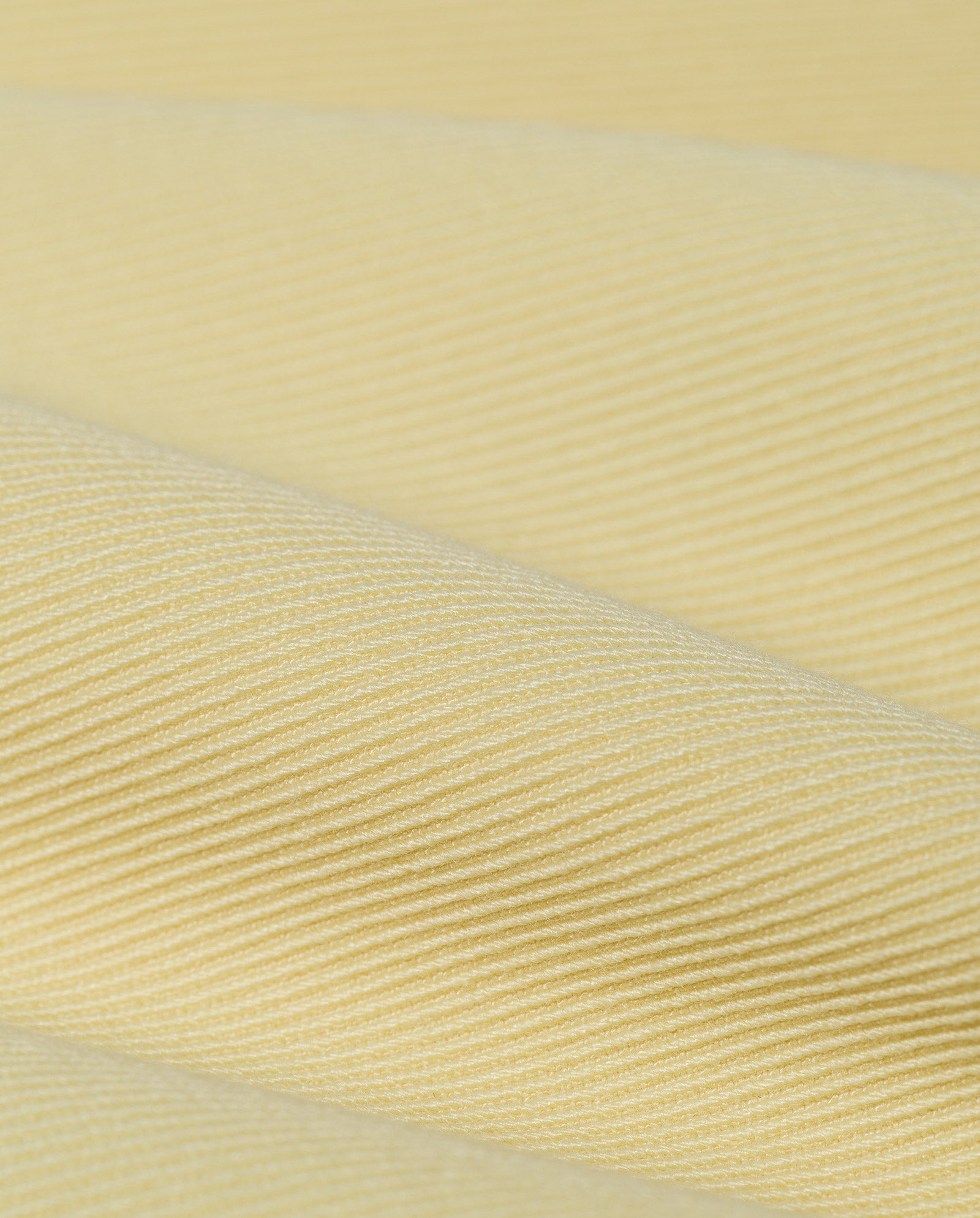 Close-up of light yellow ribbed fabric, made from a polyester-viscose blend with diagonal textured lines, featured in the PENINA Trouser by IVY OAK—ideal for stylish woven trousers or intricate patched pockets.