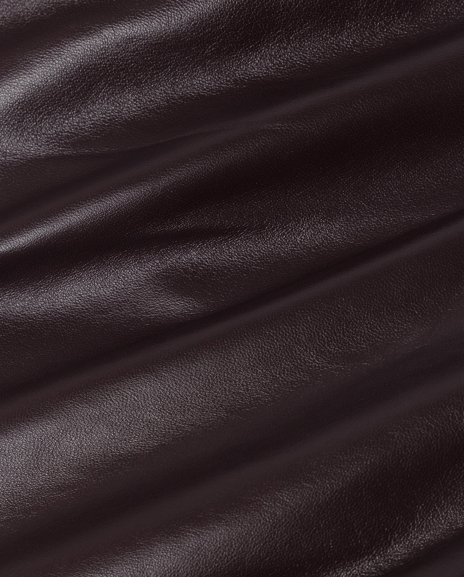 The LAURA Pants by IVY OAK feature smooth, dark brown leather with soft folds and a subtle gloss, ideal for stylish high-waist trousers.