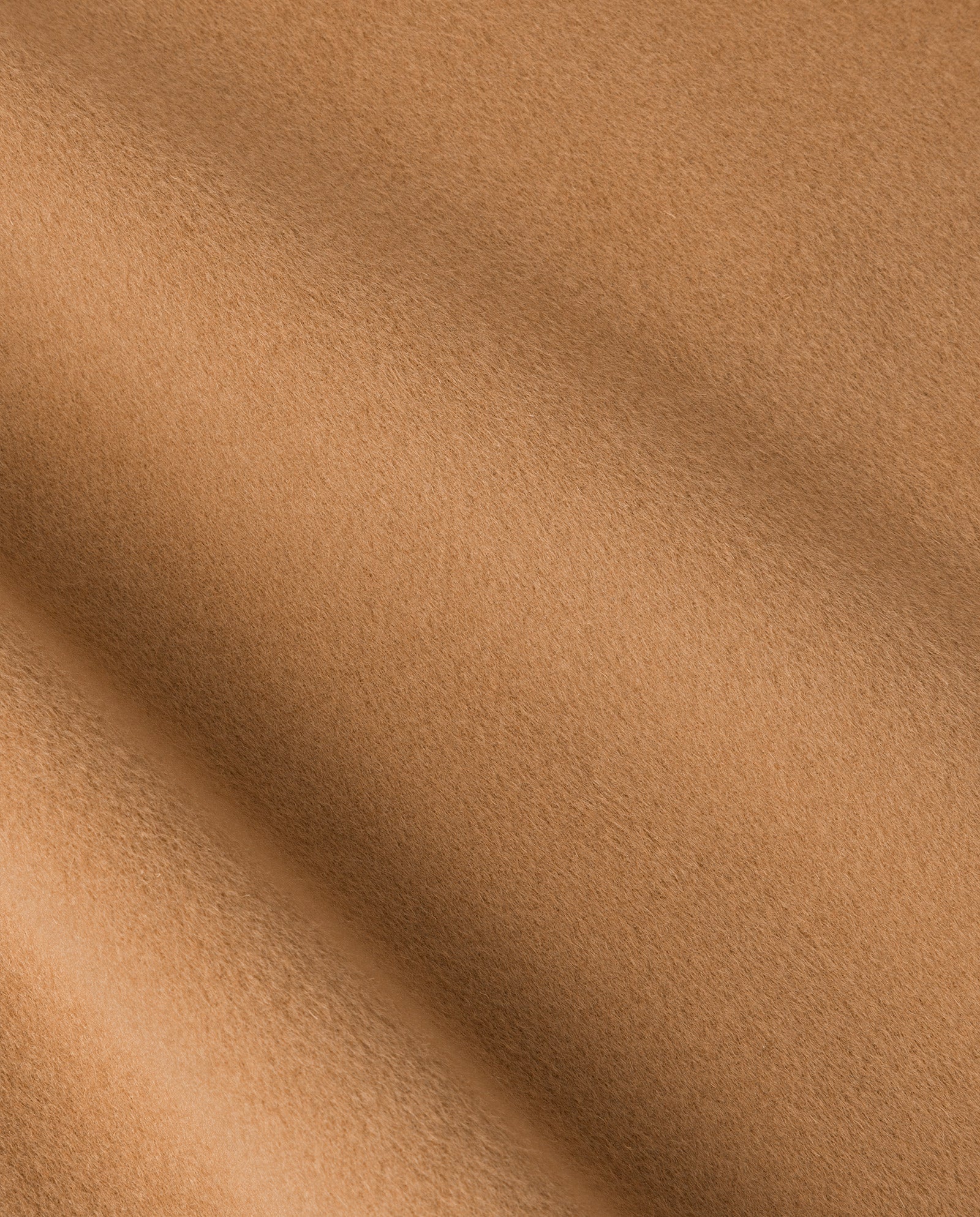 Close-up of light brown, soft textured fabric with subtle folds and a velvety appearance, characteristic of the IVY OAK JUNO Jacket crafted to Responsible Wool Standard guidelines.