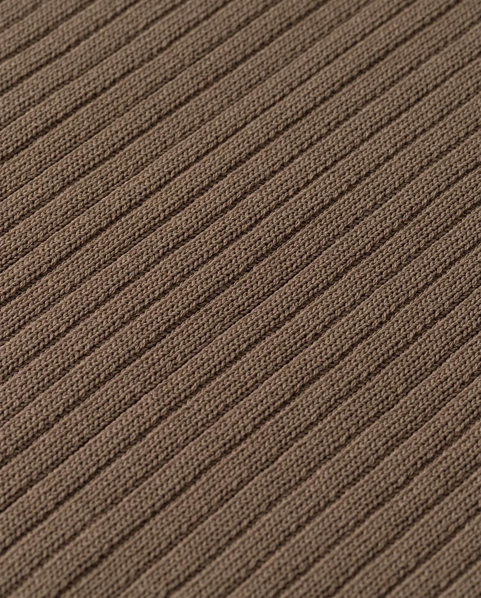 Close-up of the KESSIE Top by IVY OAK, featuring brown ribbed knit fabric with a textured vertical stripe pattern, made from stretchy material for a precise fit.