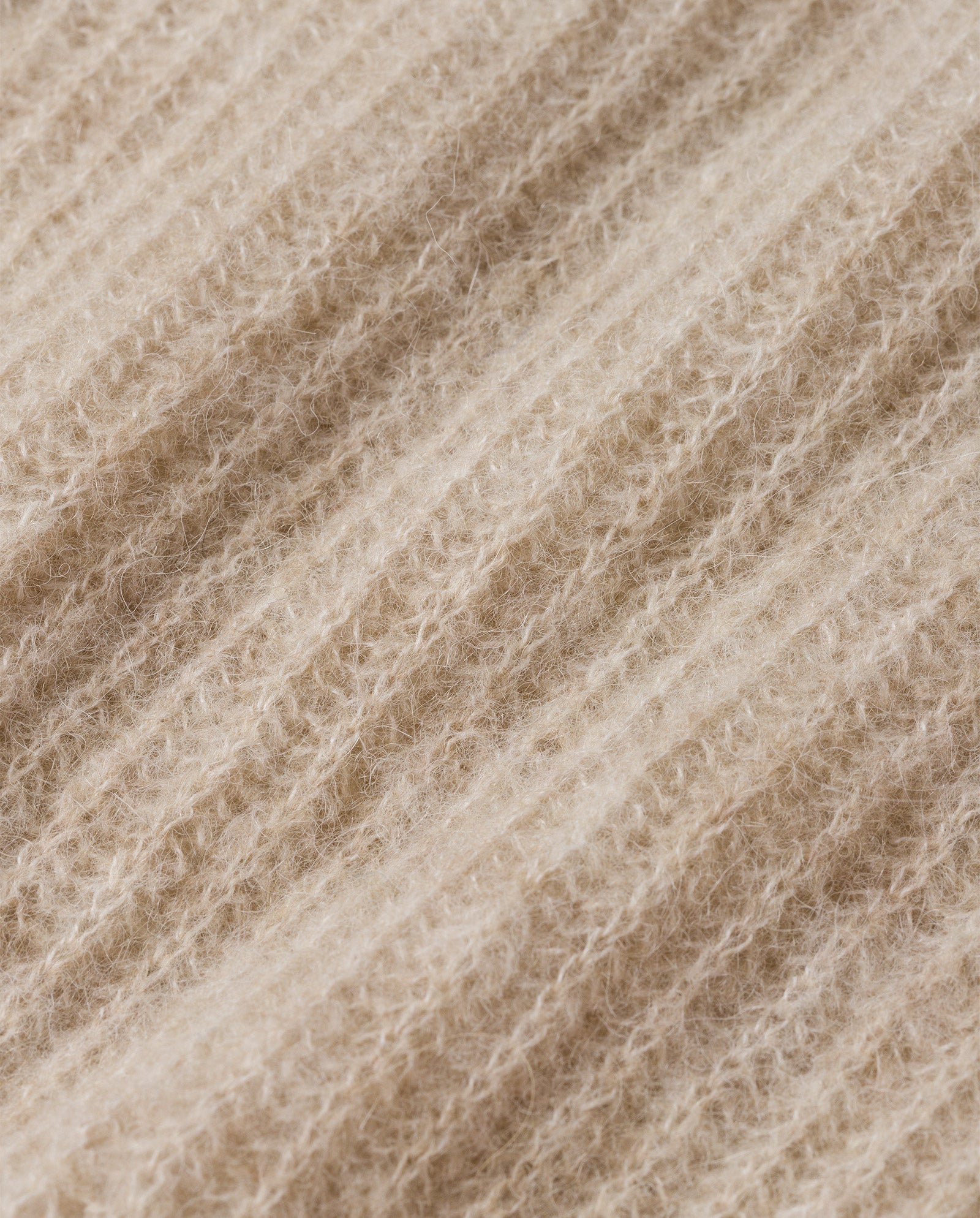 Close-up of the KEONA ANN Cardigan by IVY OAK, showcasing beige ribbed knit alpaca blend fabric with a soft, fuzzy texture—ideal for cozy comfort.