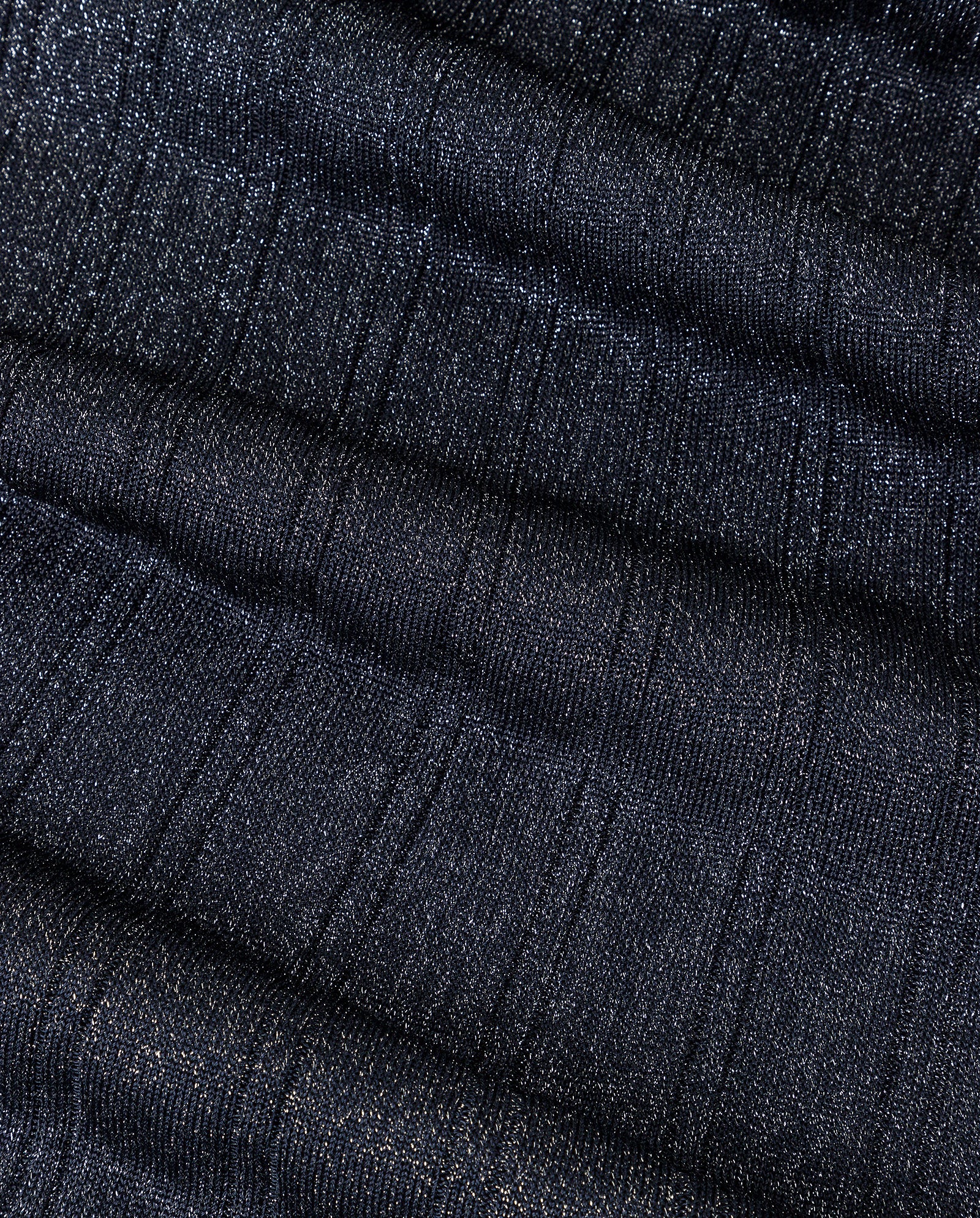 Close-up of dark, shimmery ribbed fabric with horizontal textured stripes, featuring glitter yarn details from the FLORA Dress by IVY OAK.