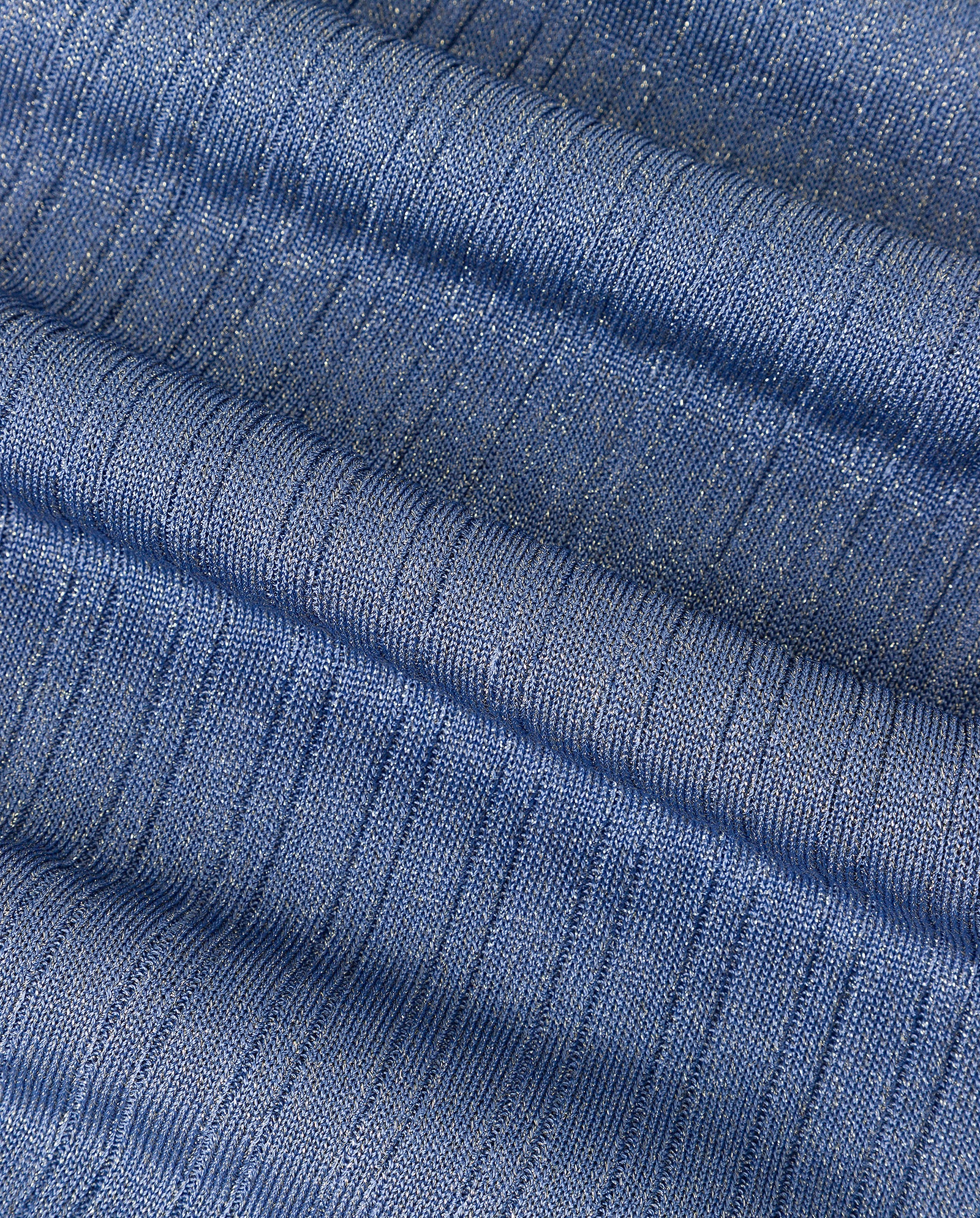 Close-up of the textured blue fabric from the FINJA Top by IVY OAK, highlighting its fitted knit design with horizontal ridges and a subtle sheen.