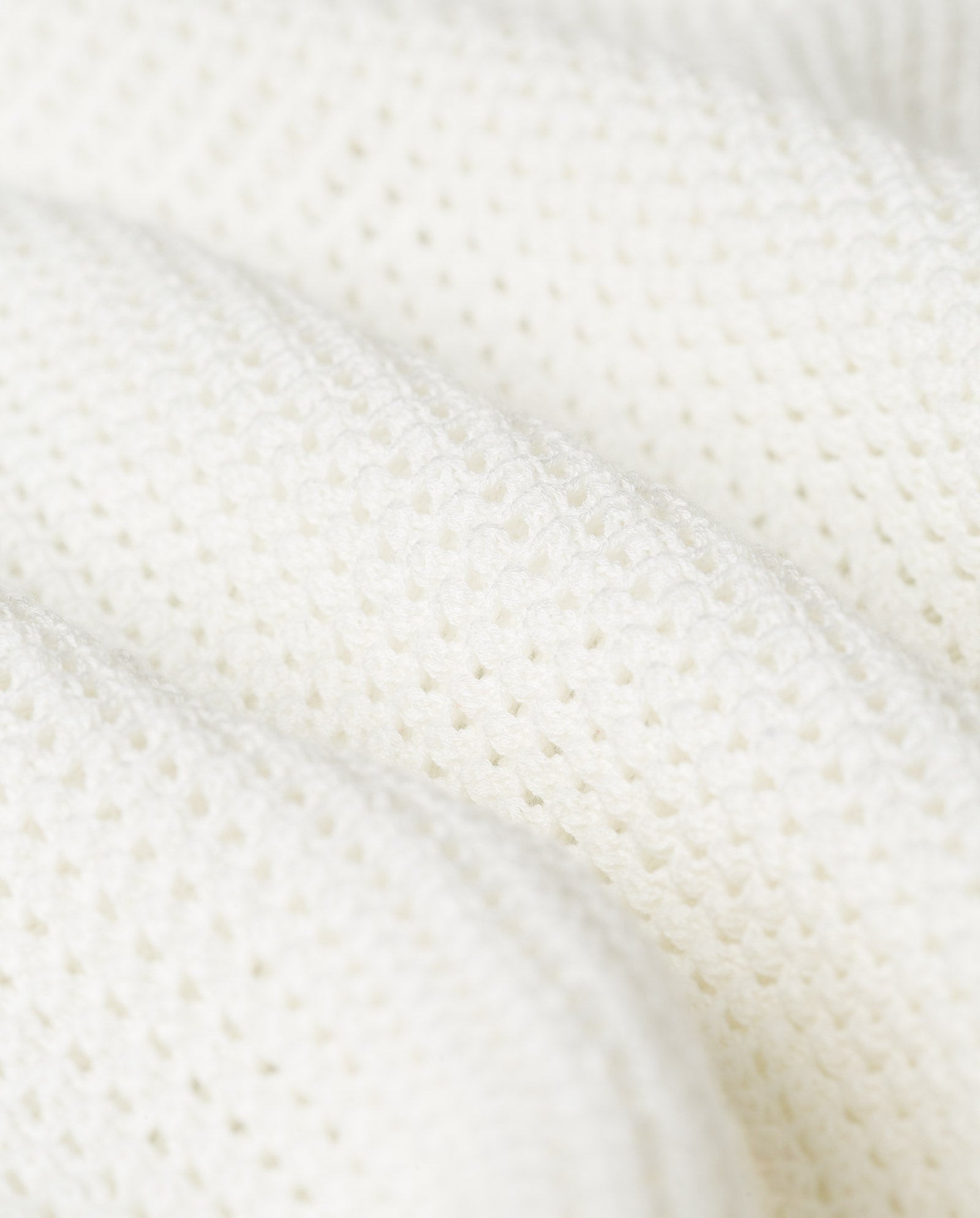 Close-up of the IVY OAK FABRIZIA Skirt, featuring a textured off-white open knit with small, evenly spaced holes and a breezy A-line silhouette.