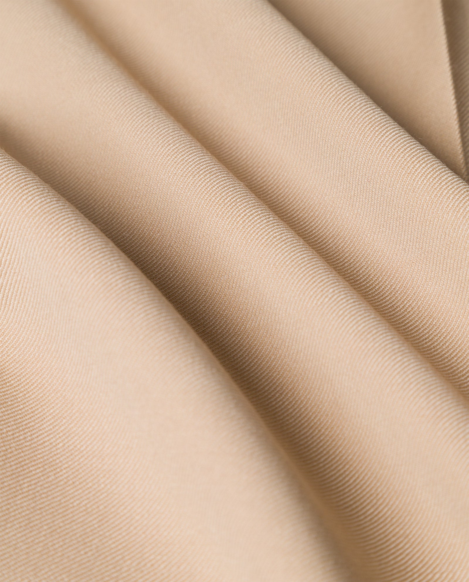Close-up of smooth, beige fabric with gentle folds and subtle shadows—perfect for the IVY OAK PRESCILLIA Trouser.
