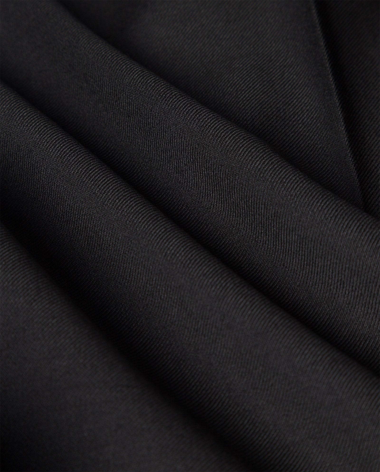 Close-up of folded black fabric from the IVY OAK PRESCILLIA Trouser, featuring a smooth, slightly textured surface—ideal for wide leg trousers.