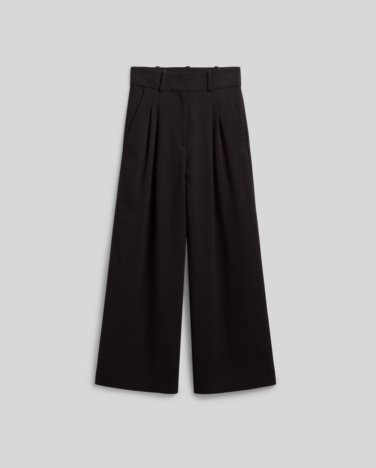 The PRESCILLIA ANN Pants by IVY OAK are wide-leg black high-waisted trousers with pleats, belt loops, and French pockets, shown laid flat on a light gray background.