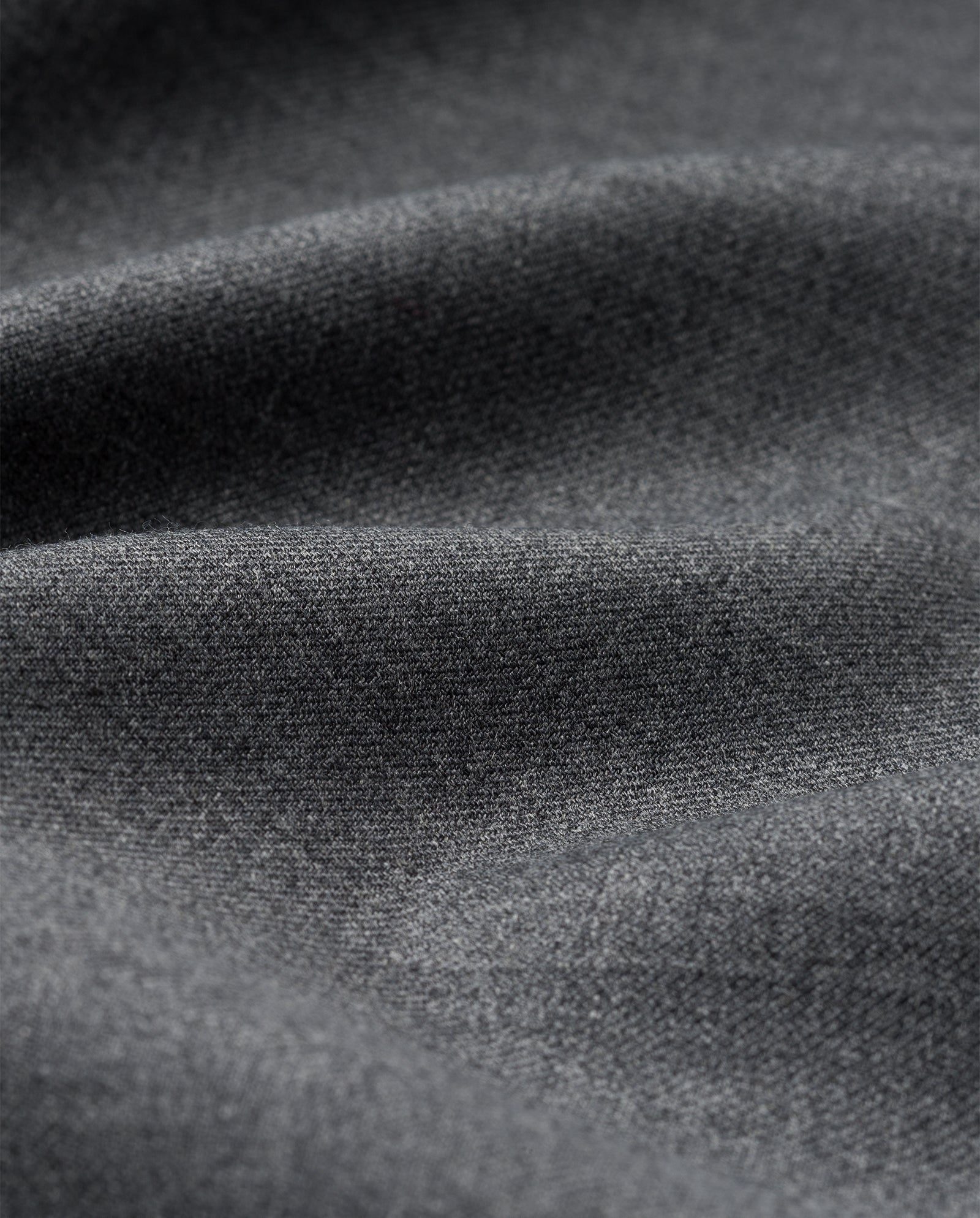 Close-up of soft, dark gray fabric with gentle folds and a smooth, subtly textured surface—ideal for crafting the IVY OAK PRESCILLIA Trousers.