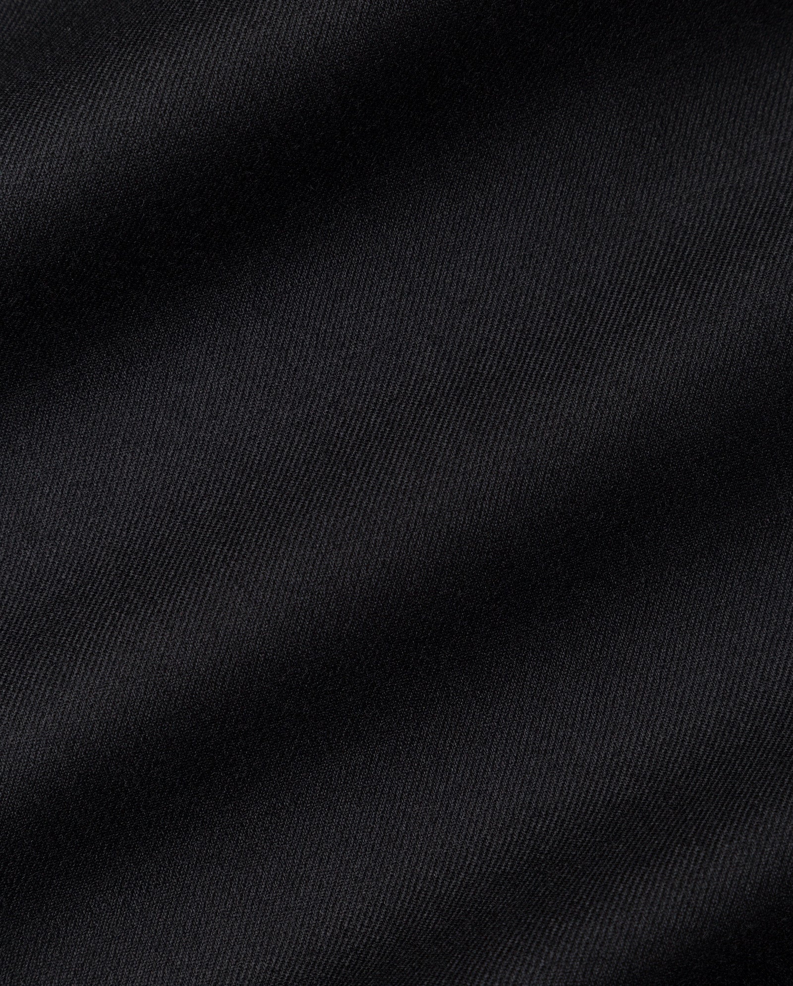 Close-up of smooth black fabric with subtle diagonal lines and soft folds, as seen on the IVY OAK POLINA ROSE Trousers.